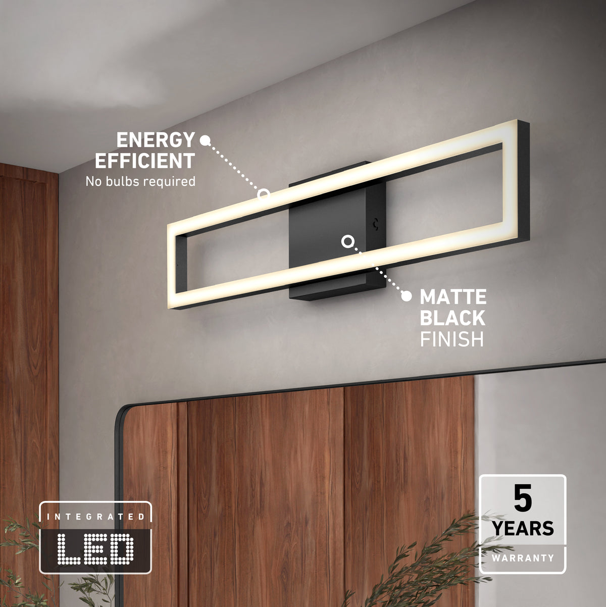 The Artika Dover 27-in Integrated LED 5-CCT Vanity Light Bar in matte black is mounted above a mirror in a modern bathroom. It features energy efficiency, integrated LEDs, and a 5-year warranty. A plant appears in the bottom right corner.