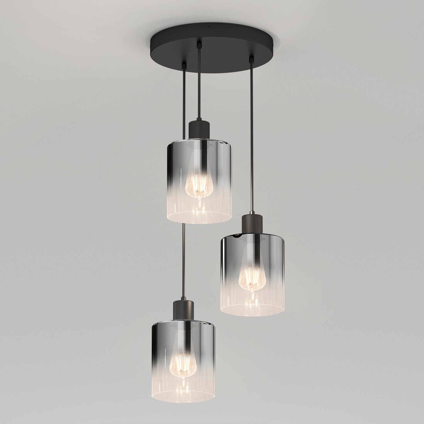 The Artika Haze modern 3-light pendant features three clear glass shades with visible bulbs, each hanging at different lengths from a round black canopy.