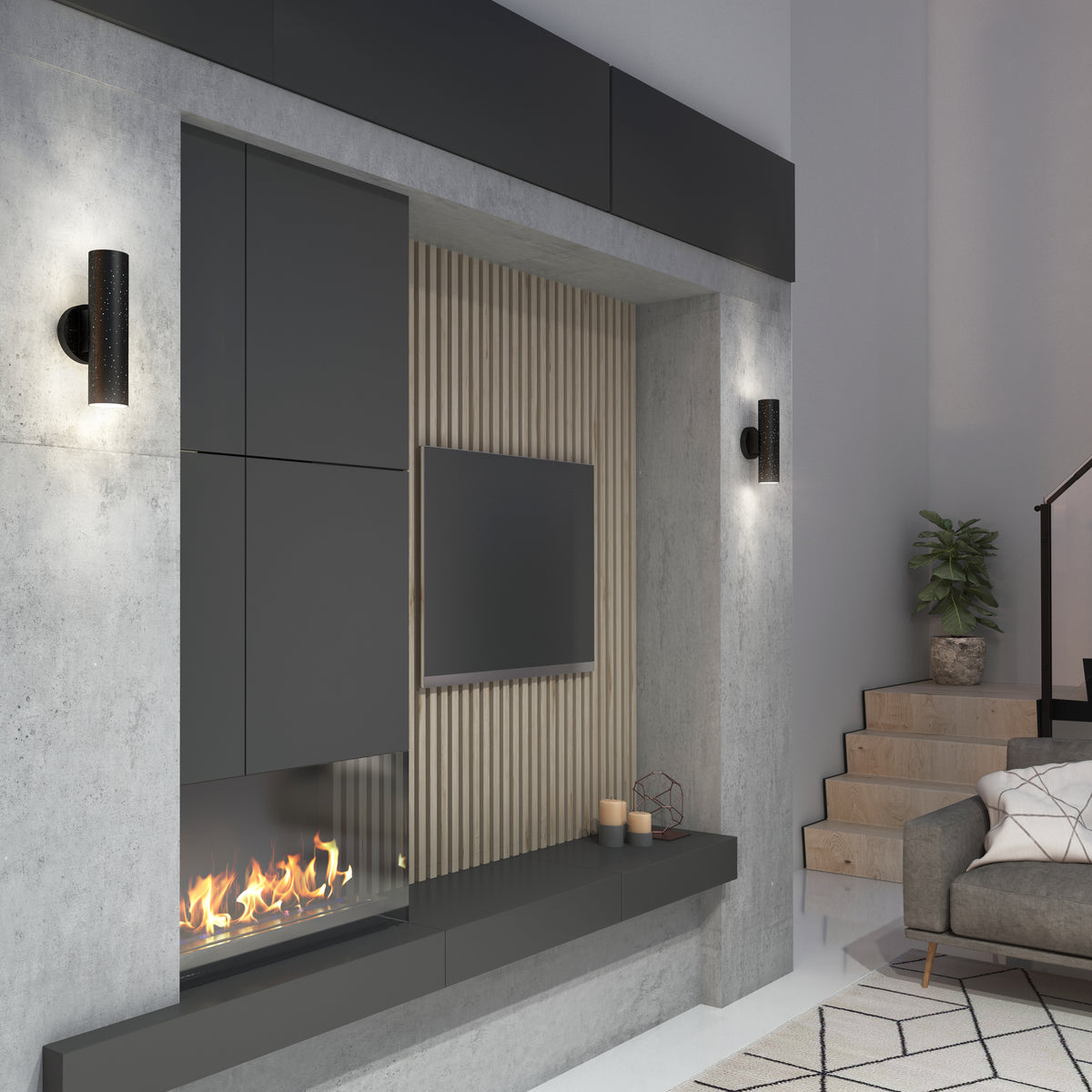 Modern living room with a built-in fireplace below a wall-mounted TV, featuring Artikas Cosmic indoor-outdoor LED wall light 3 CCT, gray cabinets, wood slats, gray sofa, stairs, potted plant, and light wood flooring.