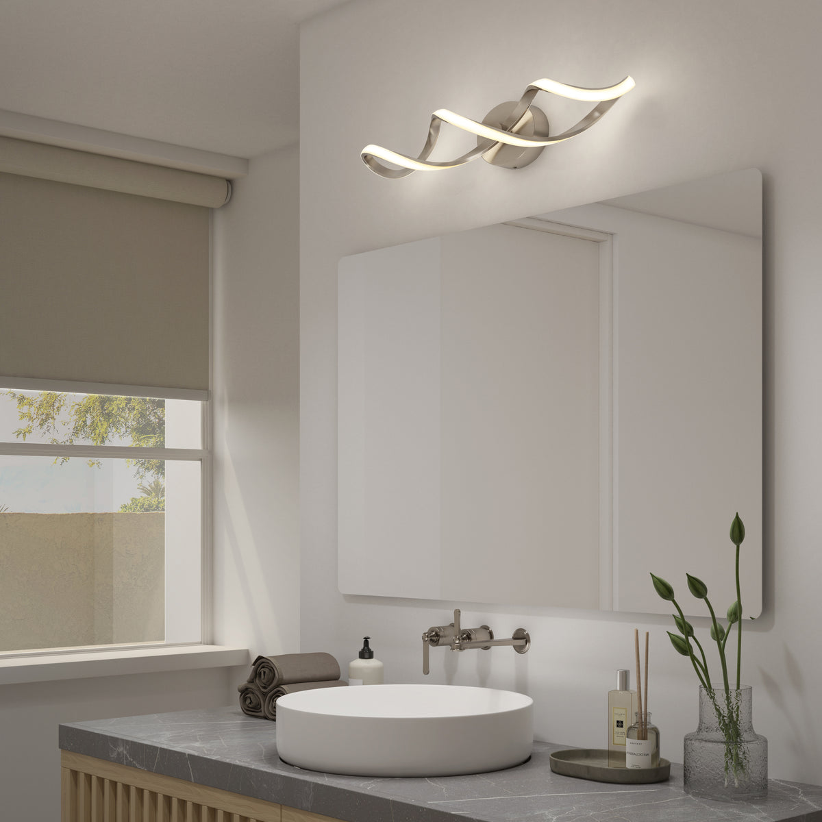 Modern bathroom featuring a round white sink, gray countertop, wall-mounted faucet, mirror, rolled towels, soap dispenser, small plants, and the Artika Swirl LED bathroom vanity light above the mirror.