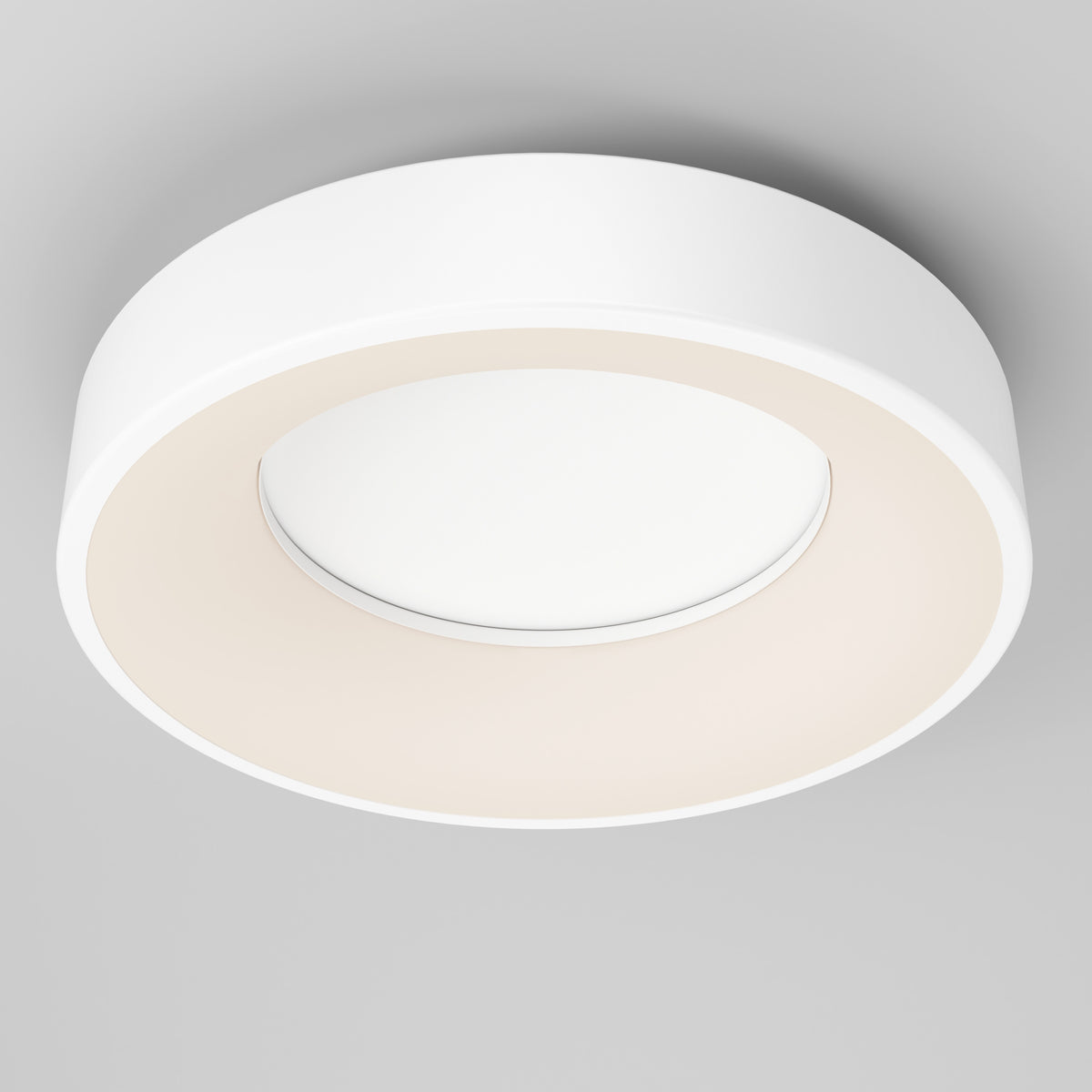 The Artika Aiden LED flush mount is a modern, circular white ceiling light with a minimalist design, mounted on a light gray ceiling. It provides evenly diffused lighting for a soft central glow.