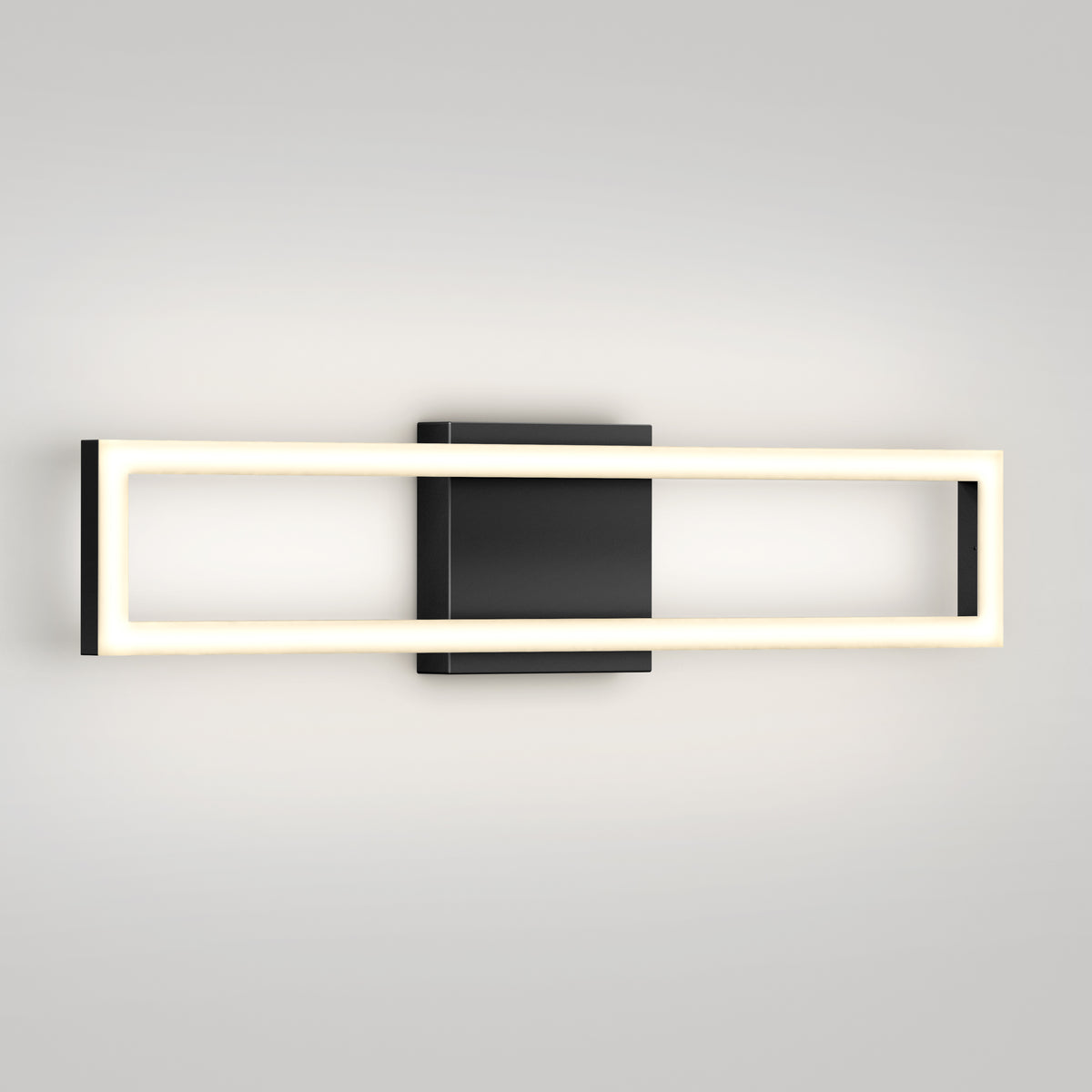 The Artika Dover 27-in (69 cm) Integrated LED 5-CCT Vanity Light Bar features a rectangular black base and illuminated frame, creating a soft glow against a light gray wall—perfect for adding sleek, modern style to any bathroom.