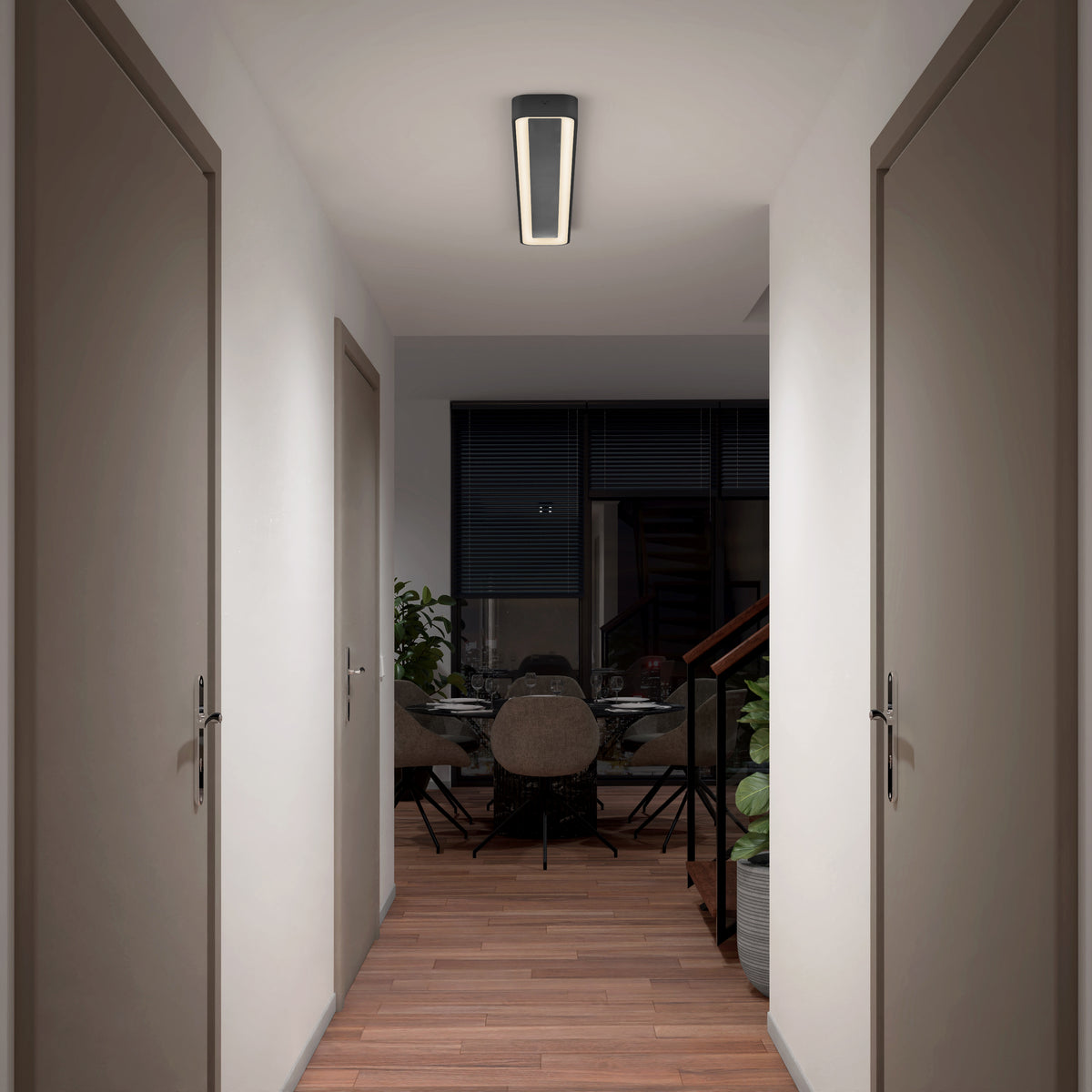 A hallway with wooden floors, white walls, and four doors per side leads to a dining area by large windows with dark blinds. An Artika Aiden 48 in. LED modern flush mount light 5 CCT brightens the space.