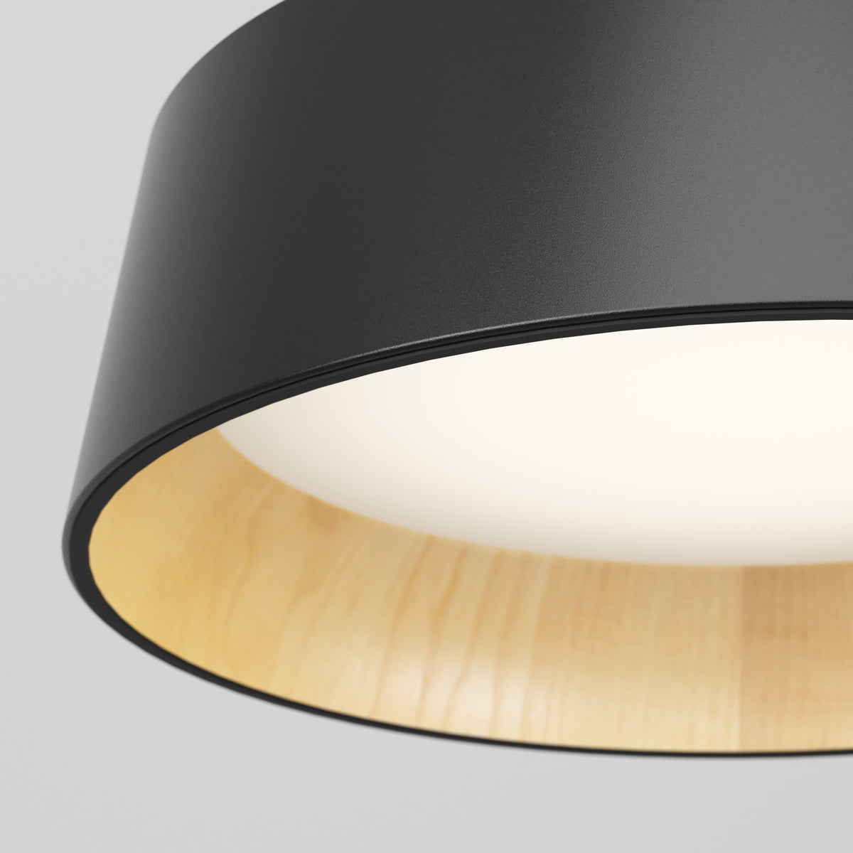 Close-up of the Alton modern LED pendant light 5 CCT by Artika, featuring a matte black exterior, light wooden interior, and a softly glowing white diffuser.
