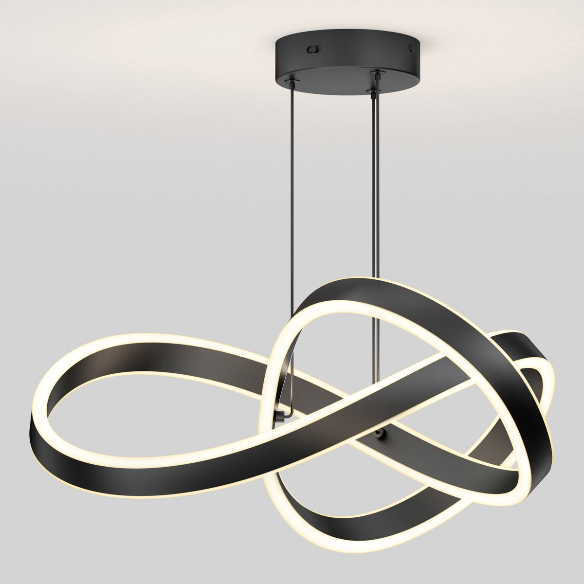 The Artika Bolero LED pendant light 5 CCT features a modern black and white design with two interlocking infinity-shaped loops, hanging from the ceiling and emitting a soft glow.