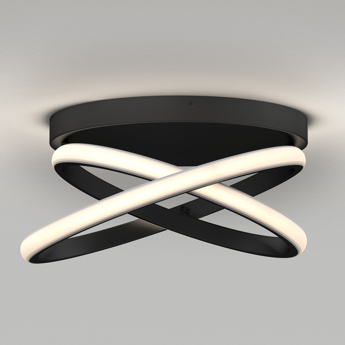 The Artika Orbia modern LED flush mount light 3 CCT features intertwined black and white rings in a sleek, abstract design, mounted on a round black base against a plain light gray ceiling.