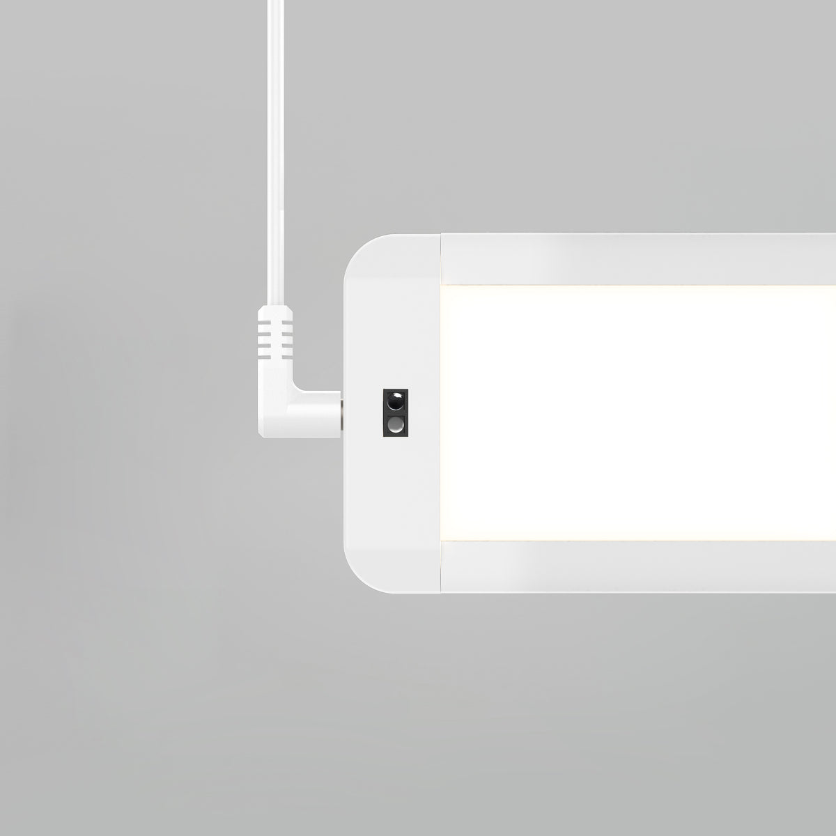 A close-up of the Artika Maestro under cabinet LED light 3CCT, a modern rectangular white fixture suspended by a white cord against a plain light gray background.