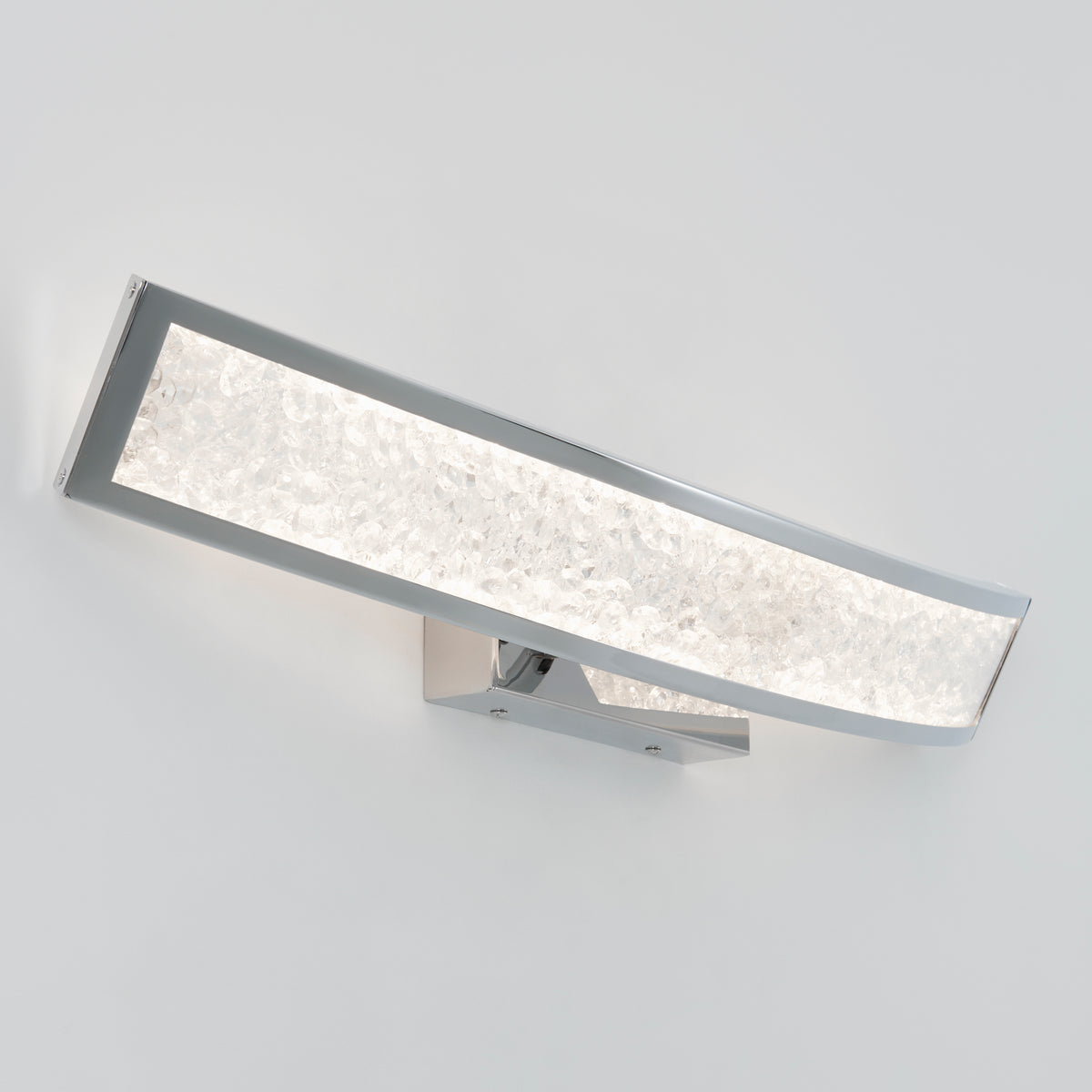 The Artika Glitter 27-in (69 cm) Integrated LED Vanity Light Bar features a textured illuminated glass panel and a sleek, slightly curved chrome frame, shown mounted on a plain white wall.