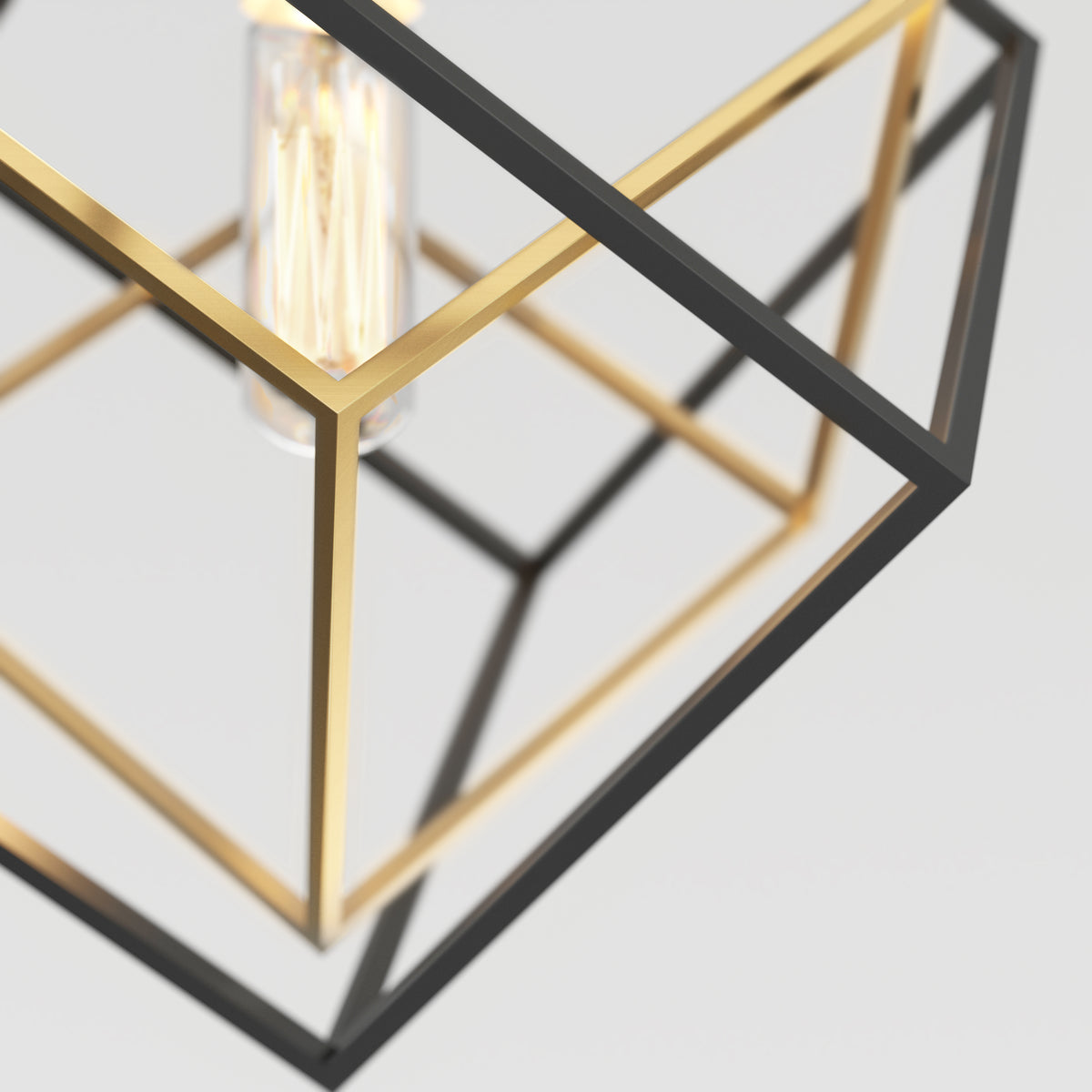 The Artika Imperium Single pendant light features intersecting gold and black metal frames in a modern geometric design with an exposed filament bulb, set against a plain, light-colored background.