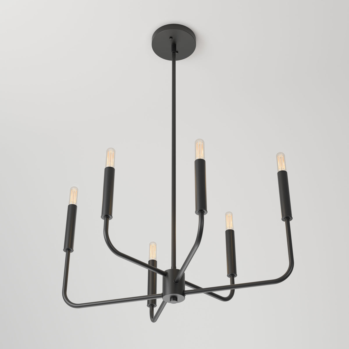 The Artika Manchester 6-light pendant features a modern black finish with six exposed bulbs on sleek, angular arms, suspended elegantly from the ceiling against a white background.