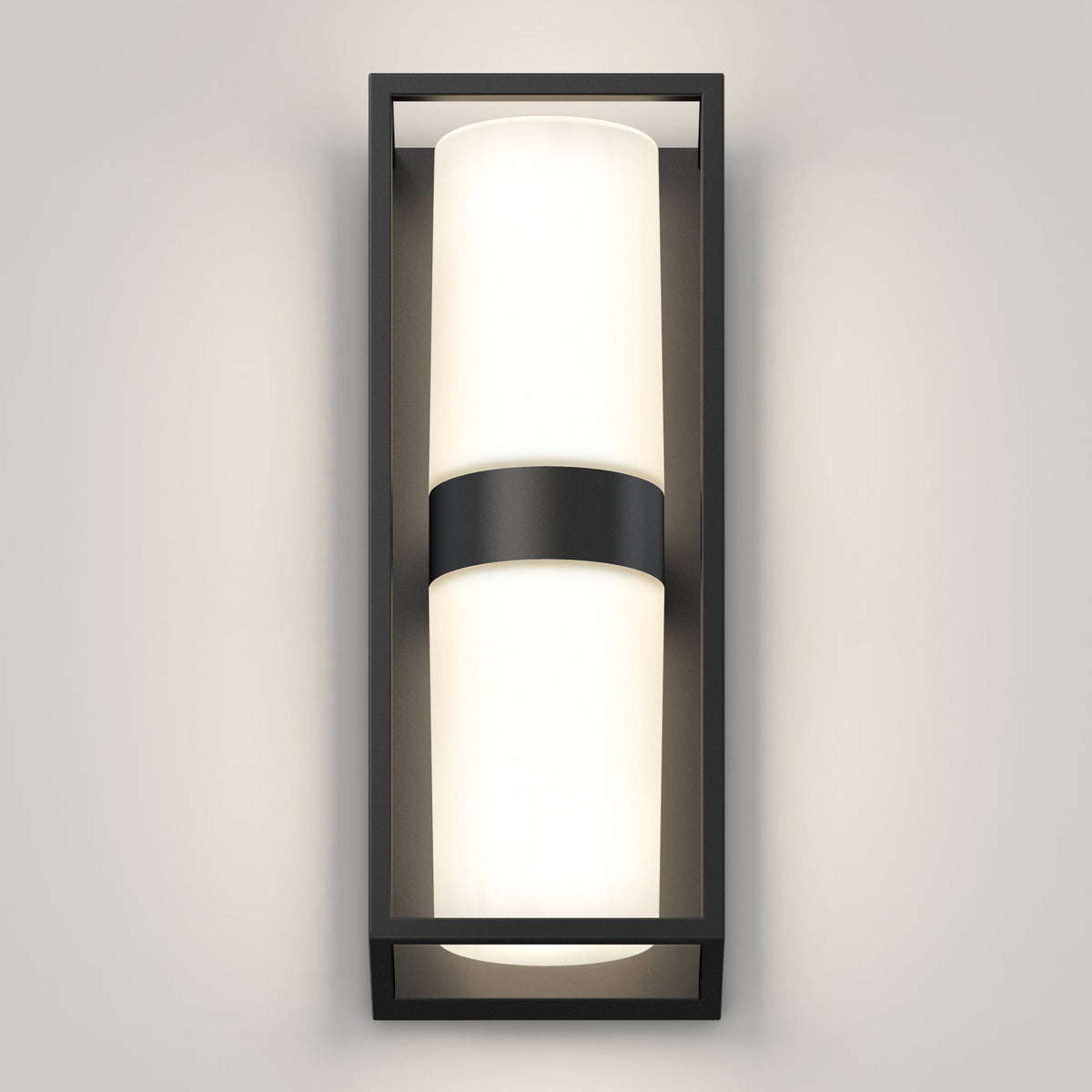 The Artika Sherman modern LED indoor-outdoor wall light 5 CCT features a rectangular black frame and cylindrical frosted glass shade, mounted vertically on a light gray wall for soft, even illumination.