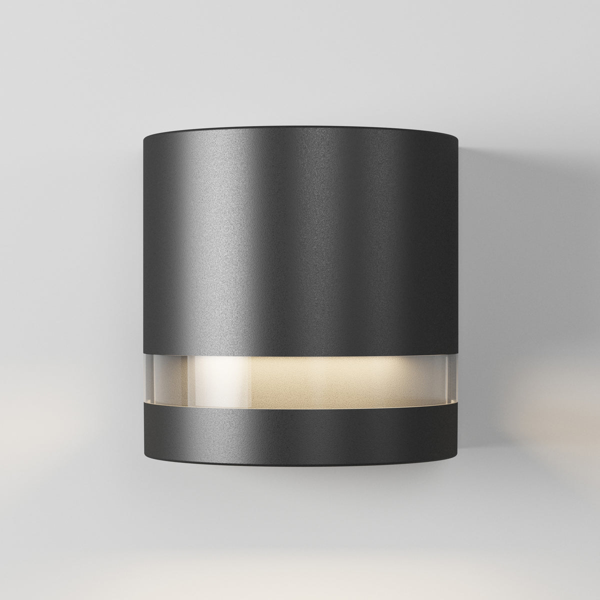 Artika’s Valor Round LED wall light features modern black design and frosted accents, casting soft white light on a light gray wall.