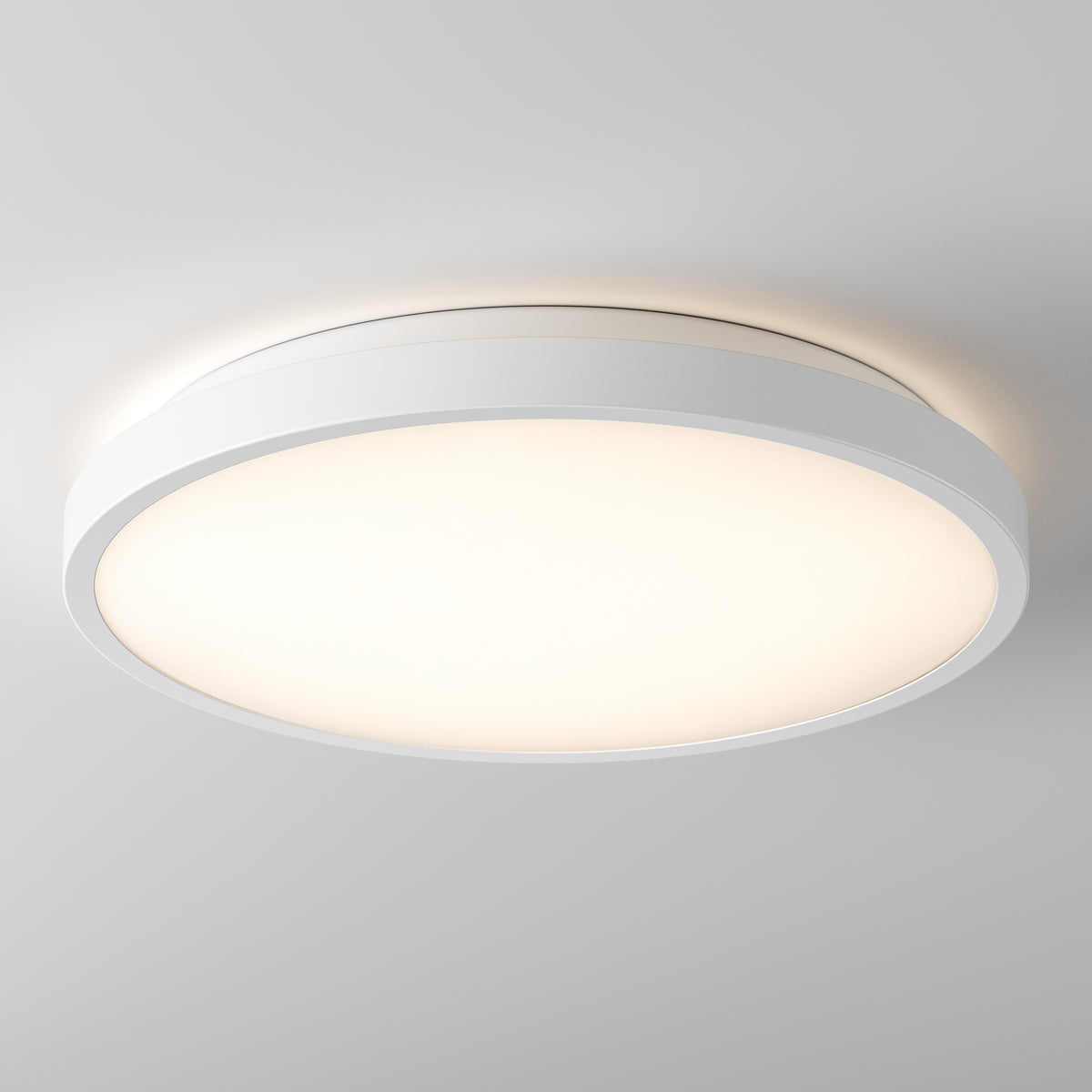 The Artika Isara 12 in. RGBIC LED Flush Mount shines with a sleek white frame against a plain white ceiling.