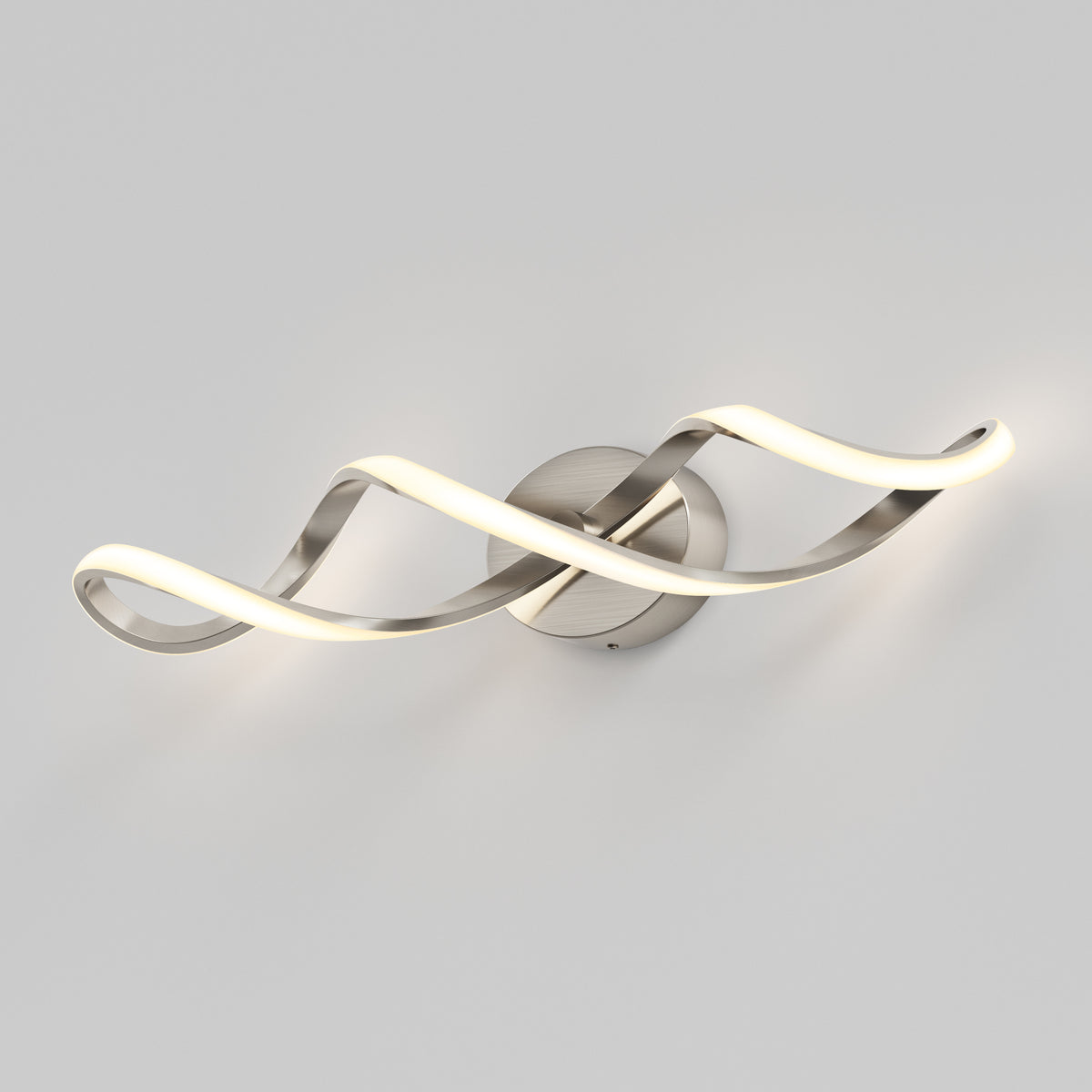 The Artika Swirl LED bathroom vanity light features two intertwined, wave-like LED strips mounted on a round metallic base, softly illuminating a plain light gray wall.