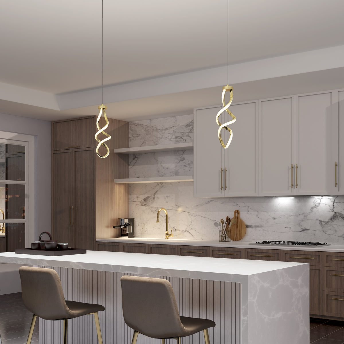 Modern kitchen with marble countertops and backsplash, two Artika Mini Swirl LED pendant lights above a white island with two beige barstools, wood cabinetry with gold fixtures, and a teapot on the stove in the background.