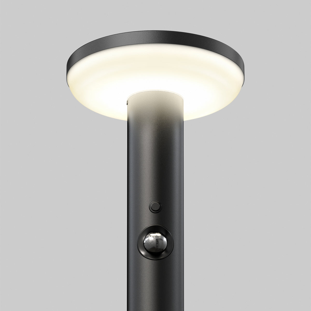 The Artika Urbia Solar LED Bollard features a black pole, round light, motion sensor button, and is shown on a plain gray background.
