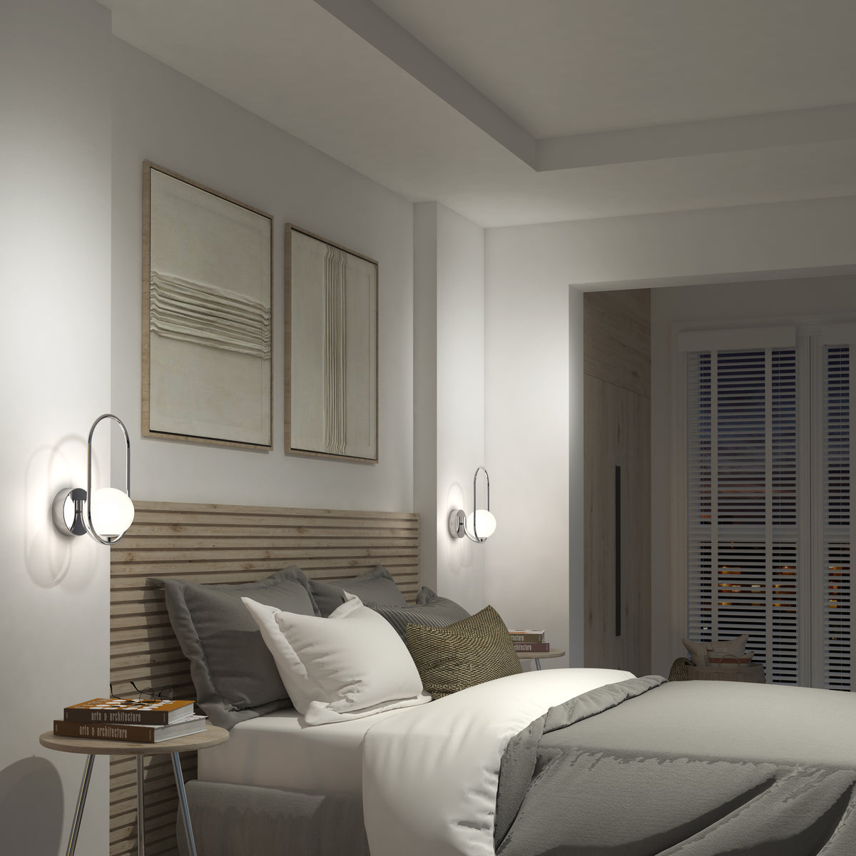 A modern bedroom features a neatly made bed with gray and white bedding, wooden bedside tables with books, abstract wall art, window blinds, and Artika Bloom LED Sconce 3 CCT lights on either side for a calm, minimalist vibe.