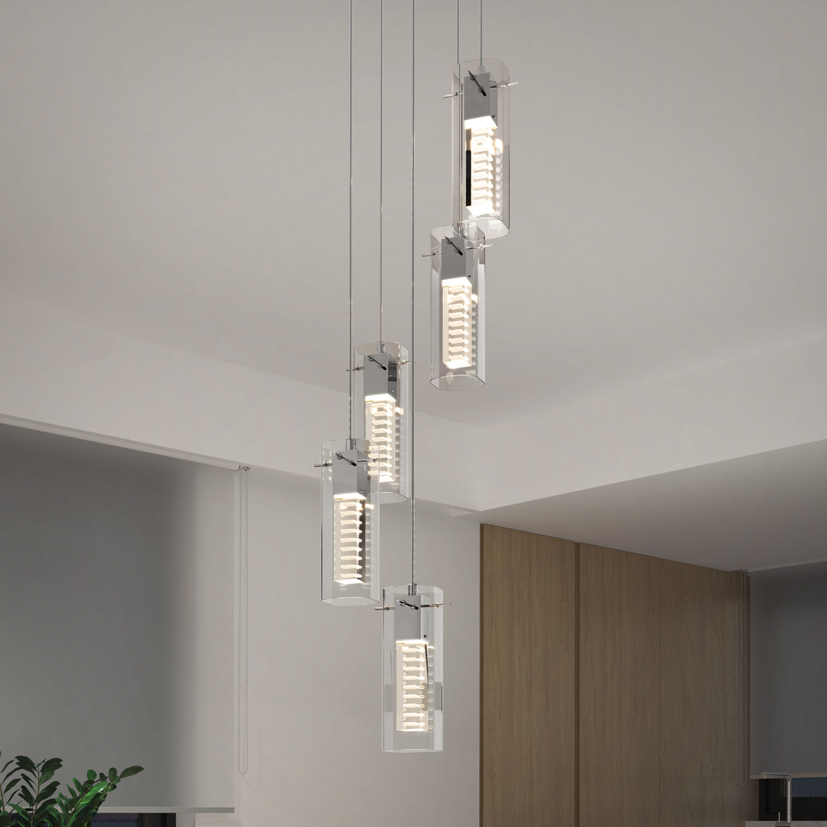 The Artika Hologram 5-light LED pendant features five rectangular glass lights in a staggered arrangement with chrome-accented circular diffusers, adding a modern touch to contemporary rooms with neutral walls and greenery.