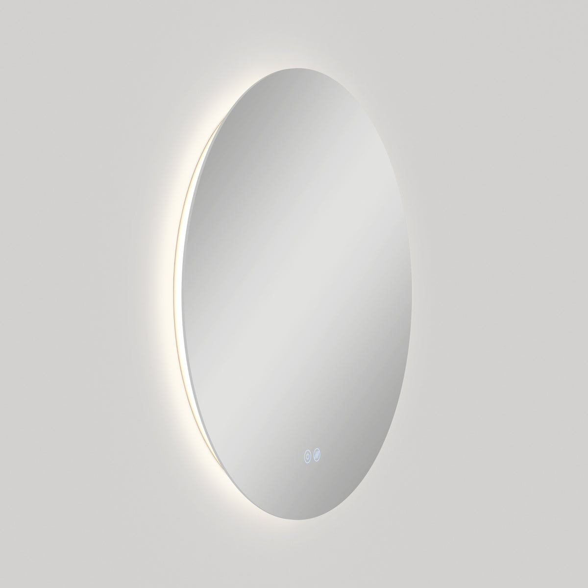 The Artika Raya 24 in. LED mirror features a soft backlight and two touch icons near the bottom edge, glowing against a plain light gray background. This wall-mounted mirror includes 3 CCT options and a built-in defogger.