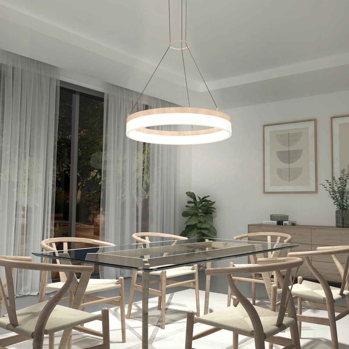 A modern dining room featuring a glass table, six wooden chairs, an Artika Optical LED pendant light 3 CCT, large windows with sheer curtains, framed abstract art on the wall, and decorative potted plants.