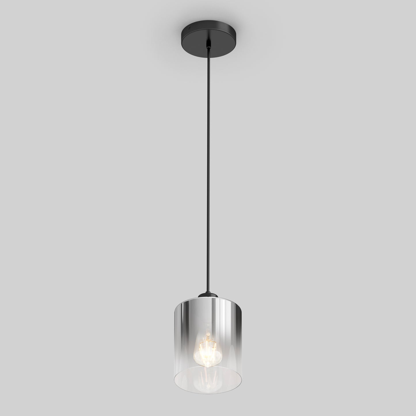 The Artika Haze pendant light glass features a modern design with a black ceiling mount and cable, a cylindrical clear glass shade, and an exposed bulb, all set against a plain light gray background.