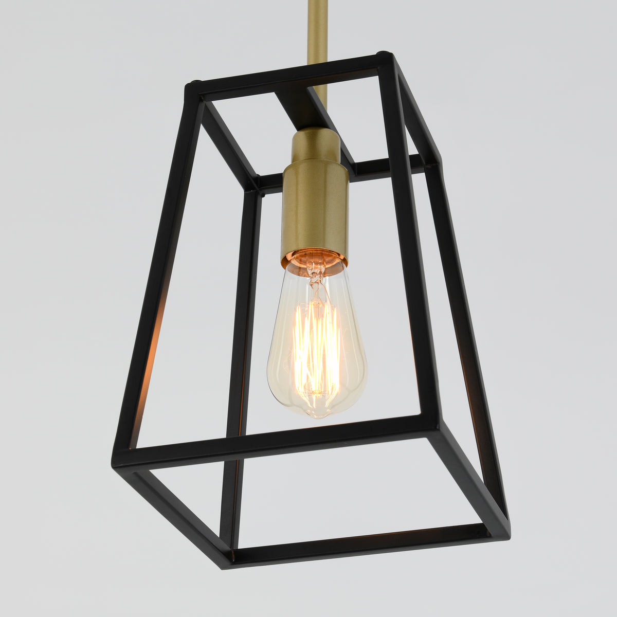 The Artika Carter 1-light pendant features a modern exposed Edison bulb set in a black geometric metal frame with a gold socket and hanging rod, shown against a plain light background.
