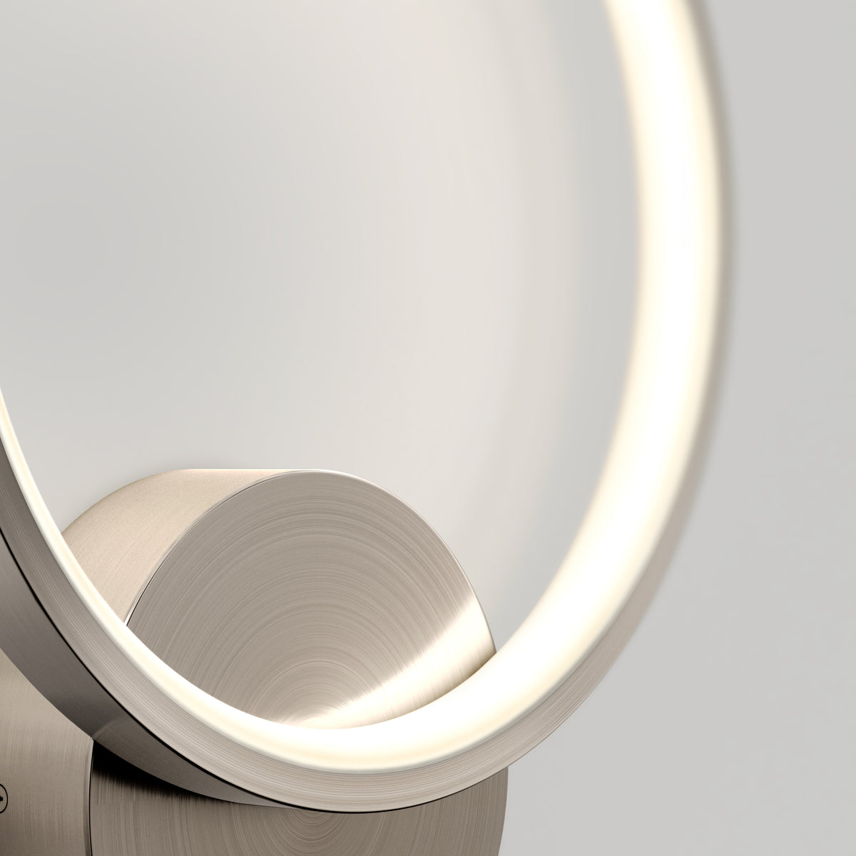 Close-up of the Artika Solis modern LED indoor-outdoor wall light 5 CCT, featuring a glowing circular design with a brushed metal base—ideal accent lighting for contemporary spaces against a neutral background.