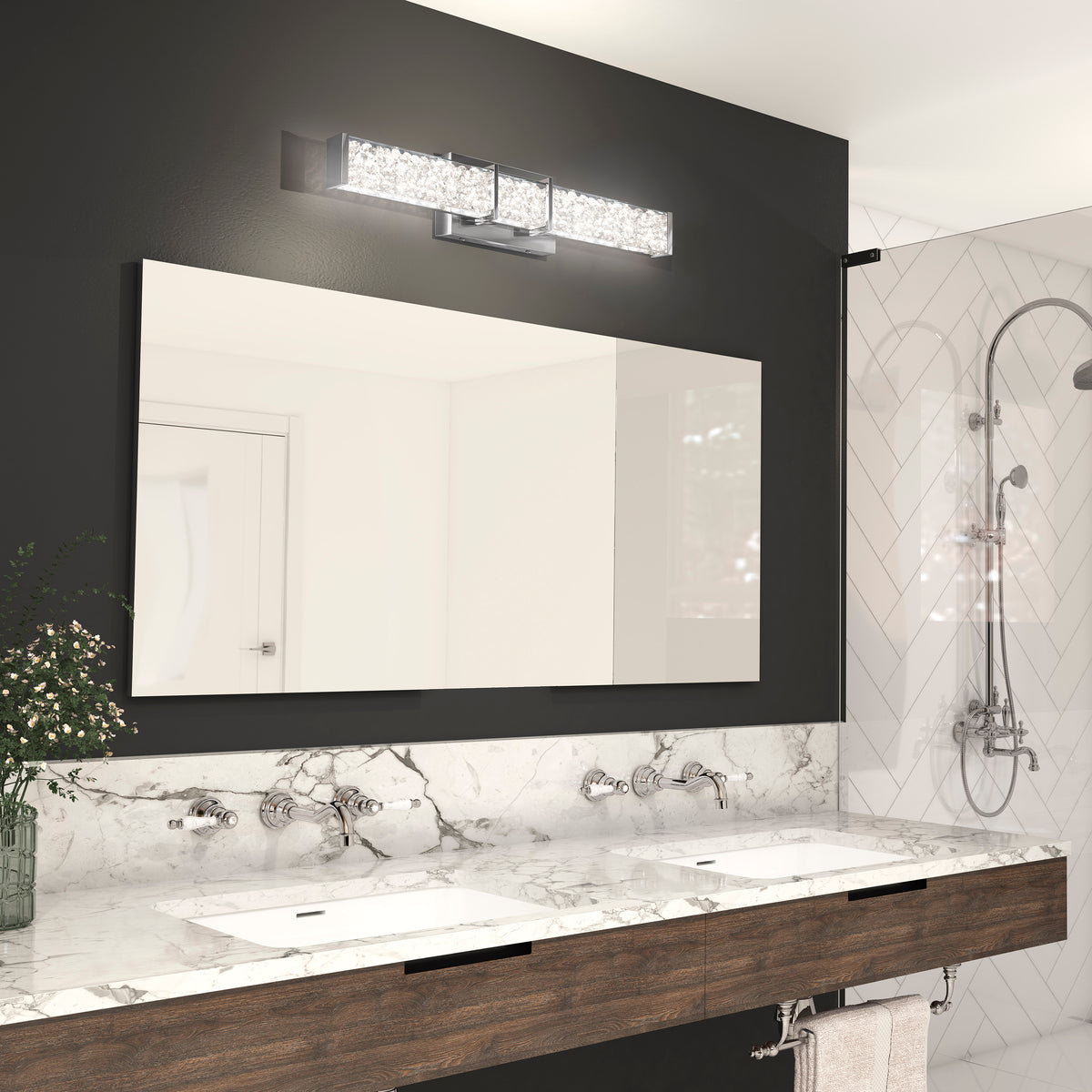 Modern bathroom with double sinks, marble countertop, Artika Royale LED light bar, dark accent wall, large mirror, and glass shower.