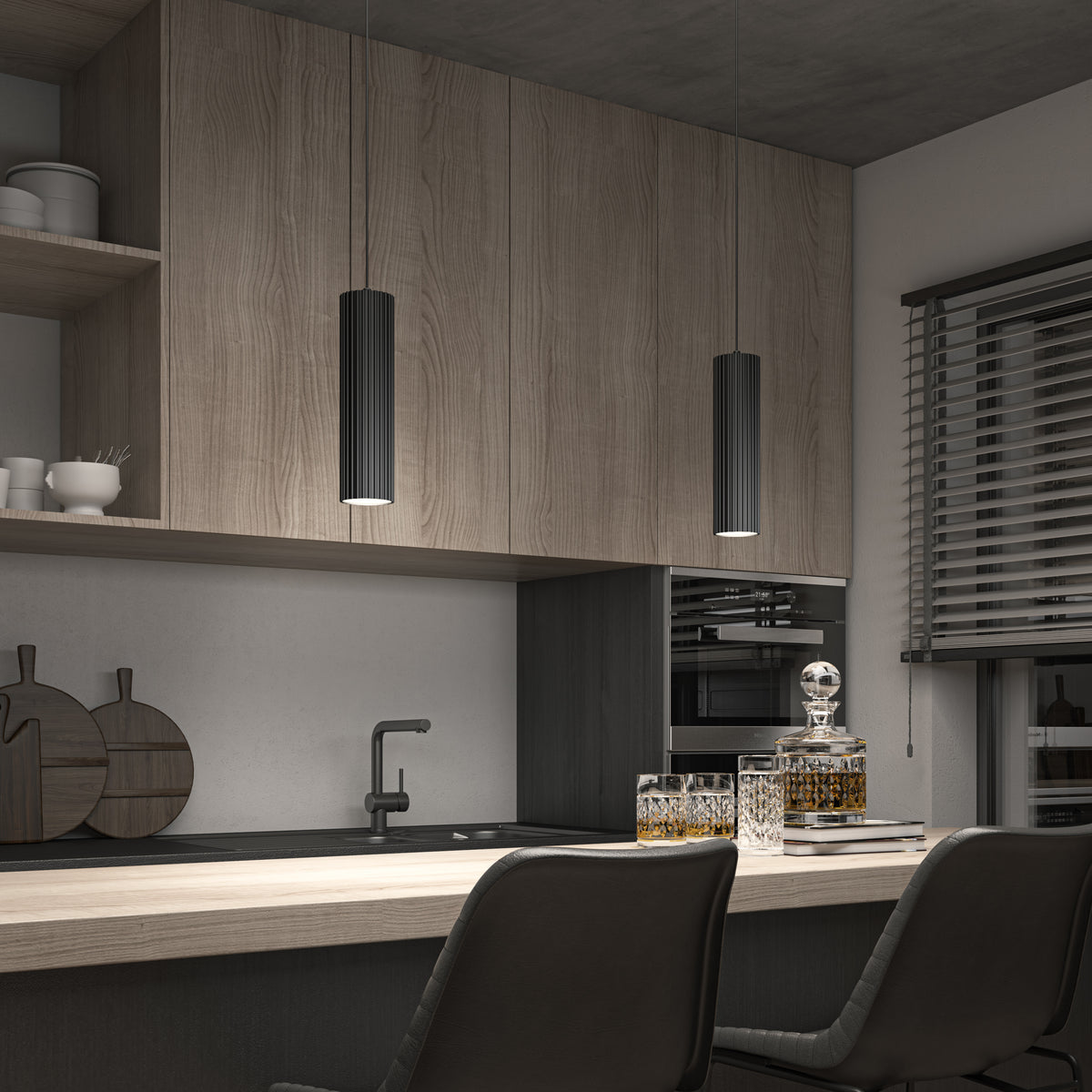 A modern kitchen features wood cabinets, two counter chairs, partially closed blinds on the right, and a decanter with glasses. Above, the Artika Groove LED modern pendant light 3 CCT provides stylish illumination.