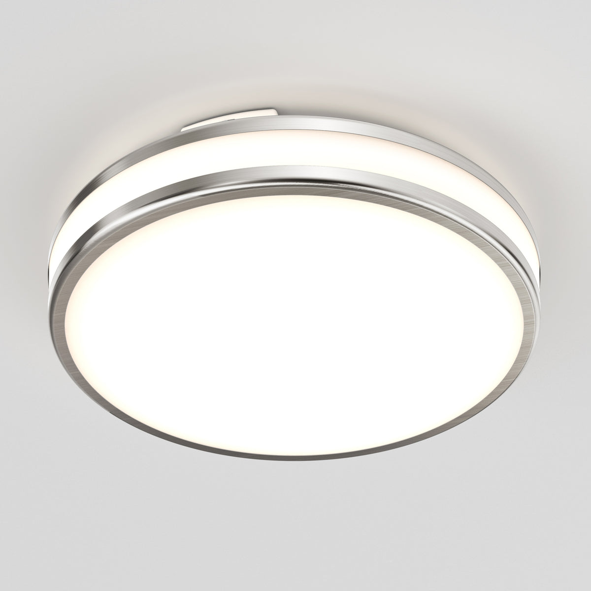 The Artika Hemisphere 15 in. LED flush mount light features a modern circular design with a metal rim and frosted white diffuser, offering adjustable brightness and 5 CCT options—perfect for bright, even bathroom lighting on any white ceiling.