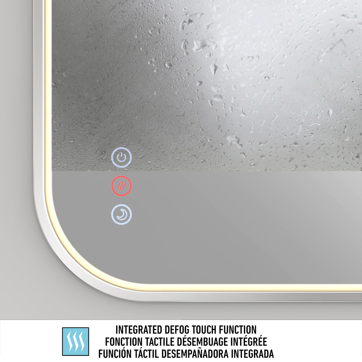 A close-up of the Artika Royce Dimmable LED Mirror (3 CCT, Horizontal/Vertical Mount) with steam on its surface, displaying blue and red illuminated touch buttons for its integrated defogger. Text below details the feature in three languages.
