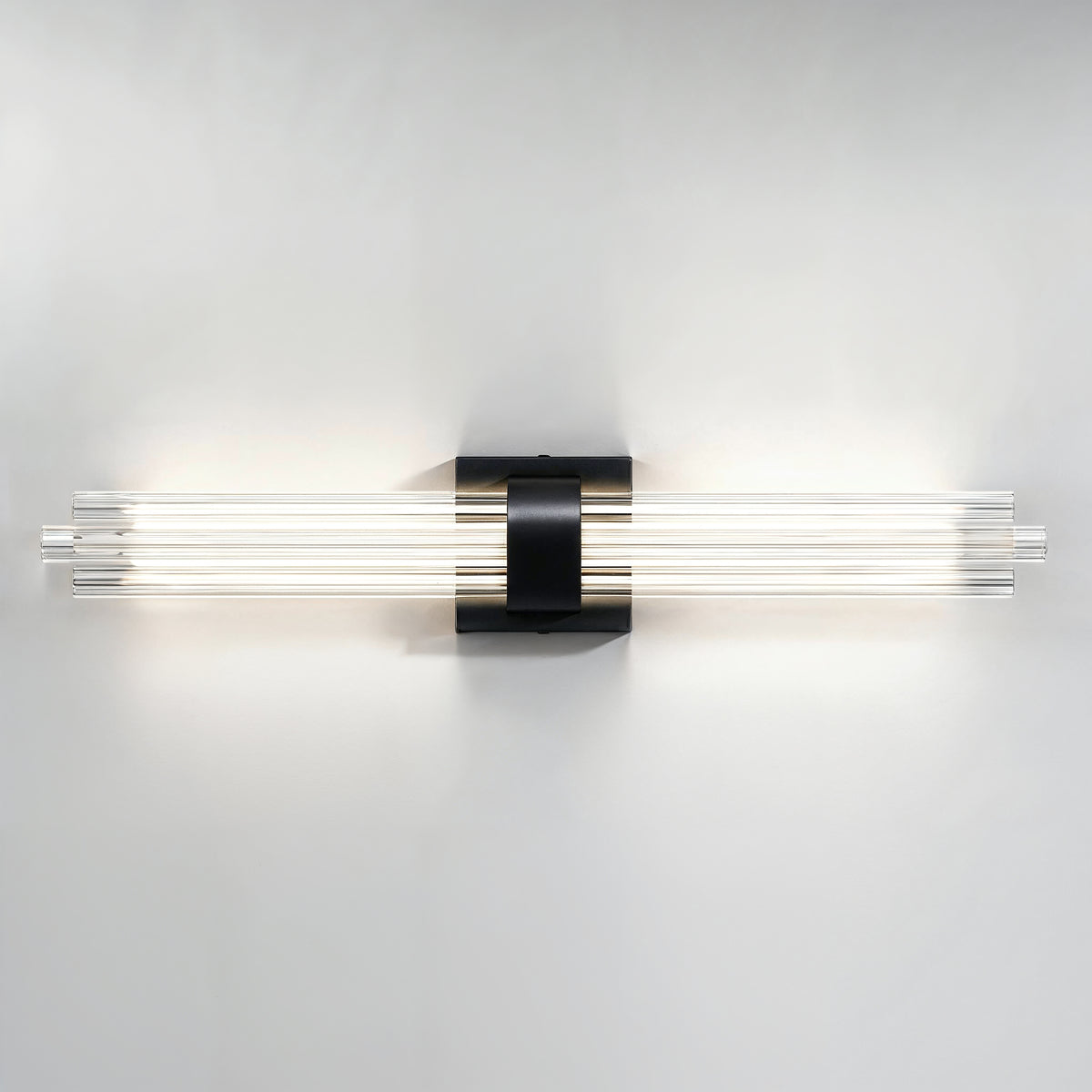 Artika Dorado 27 in. 1-Light LED Wall Vanity 5CCT features a central black mount and glowing tubes, ideal for bathroom lighting.