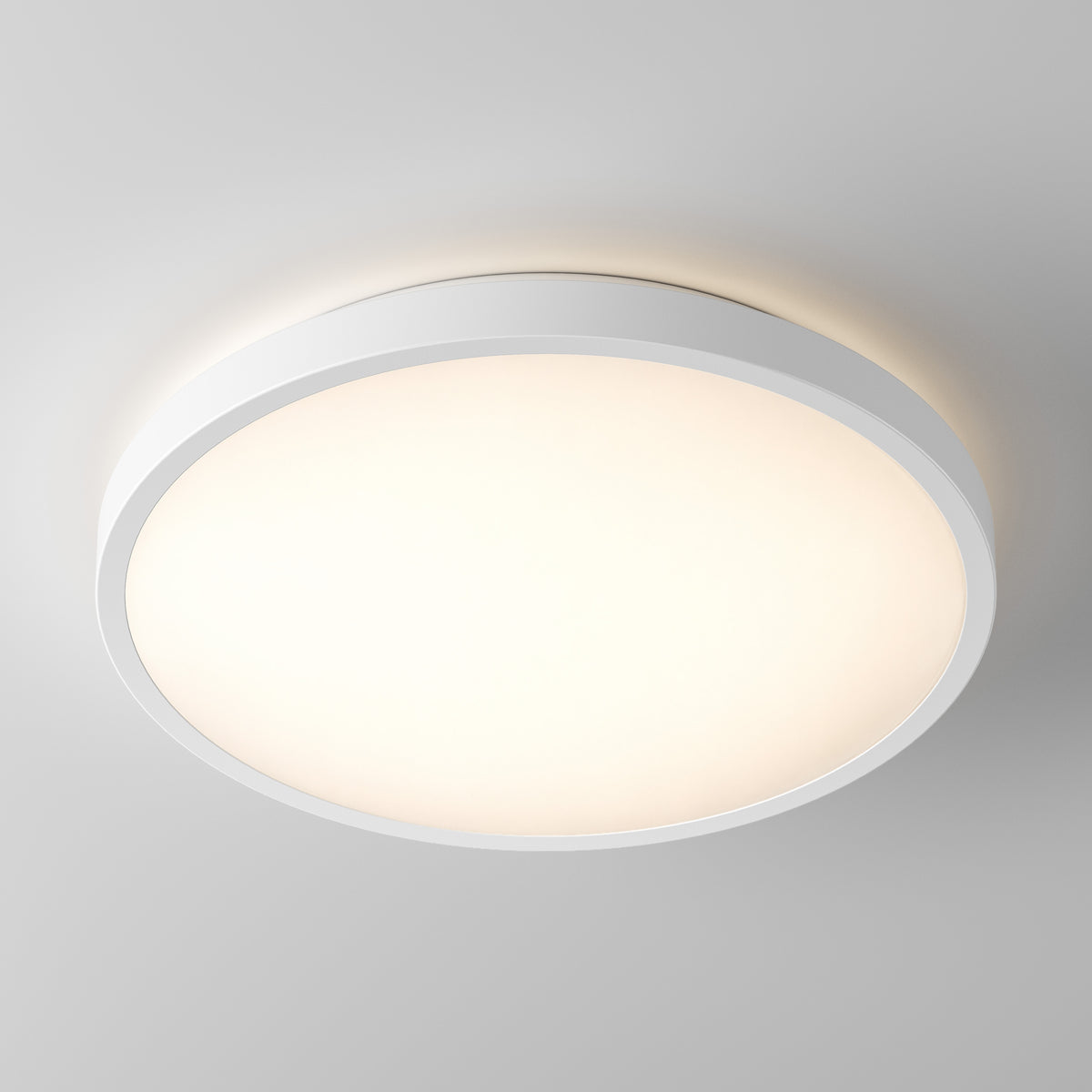 The Artika Isara 12 in. RGBIC LED Flush Mount shines on a plain ceiling with its round, white interchangeable trim.