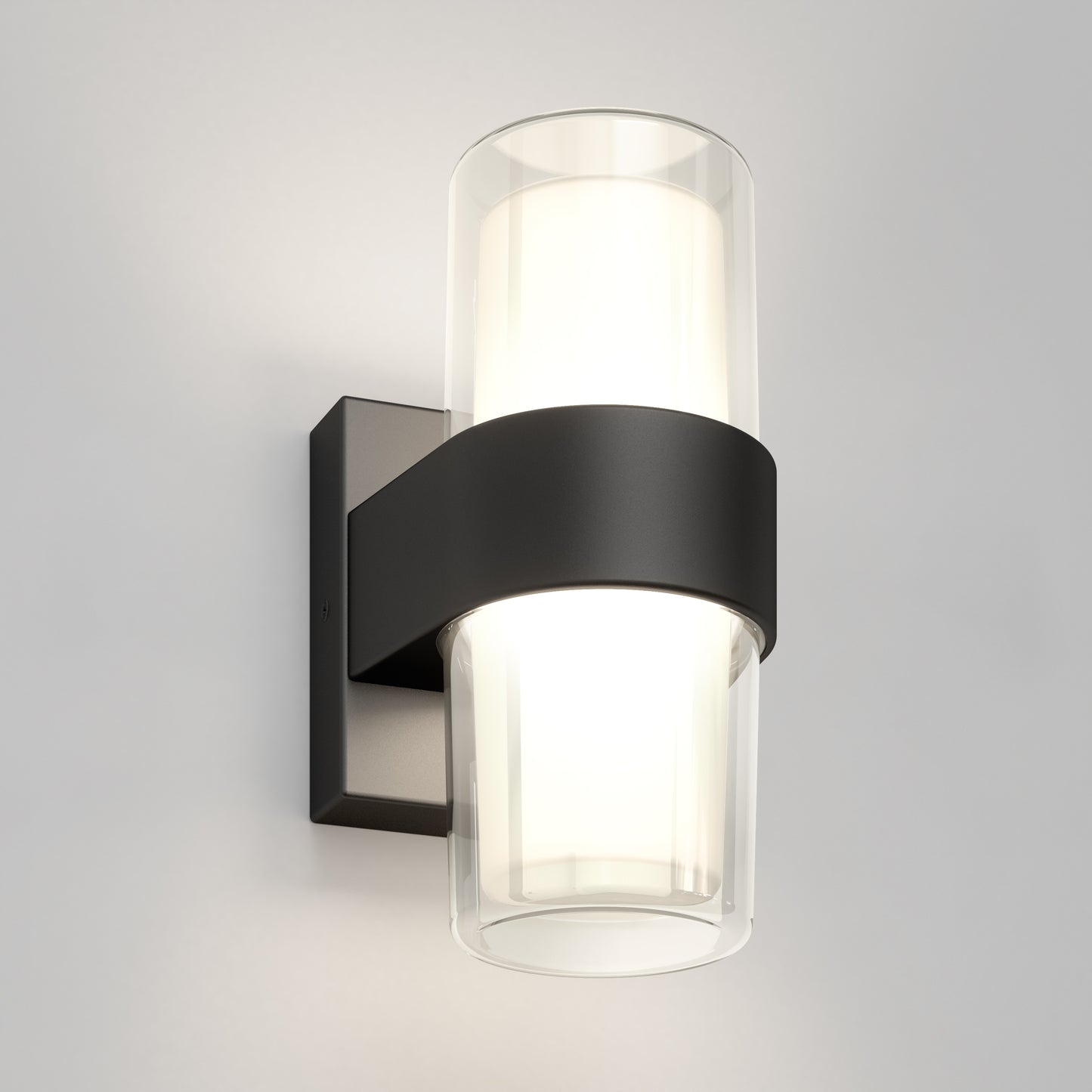 The Artika Colton modern LED indoor-outdoor wall light 5 CCT features a cylindrical frosted glass shade with a black metal band and square base, shown mounted on a light gray wall.