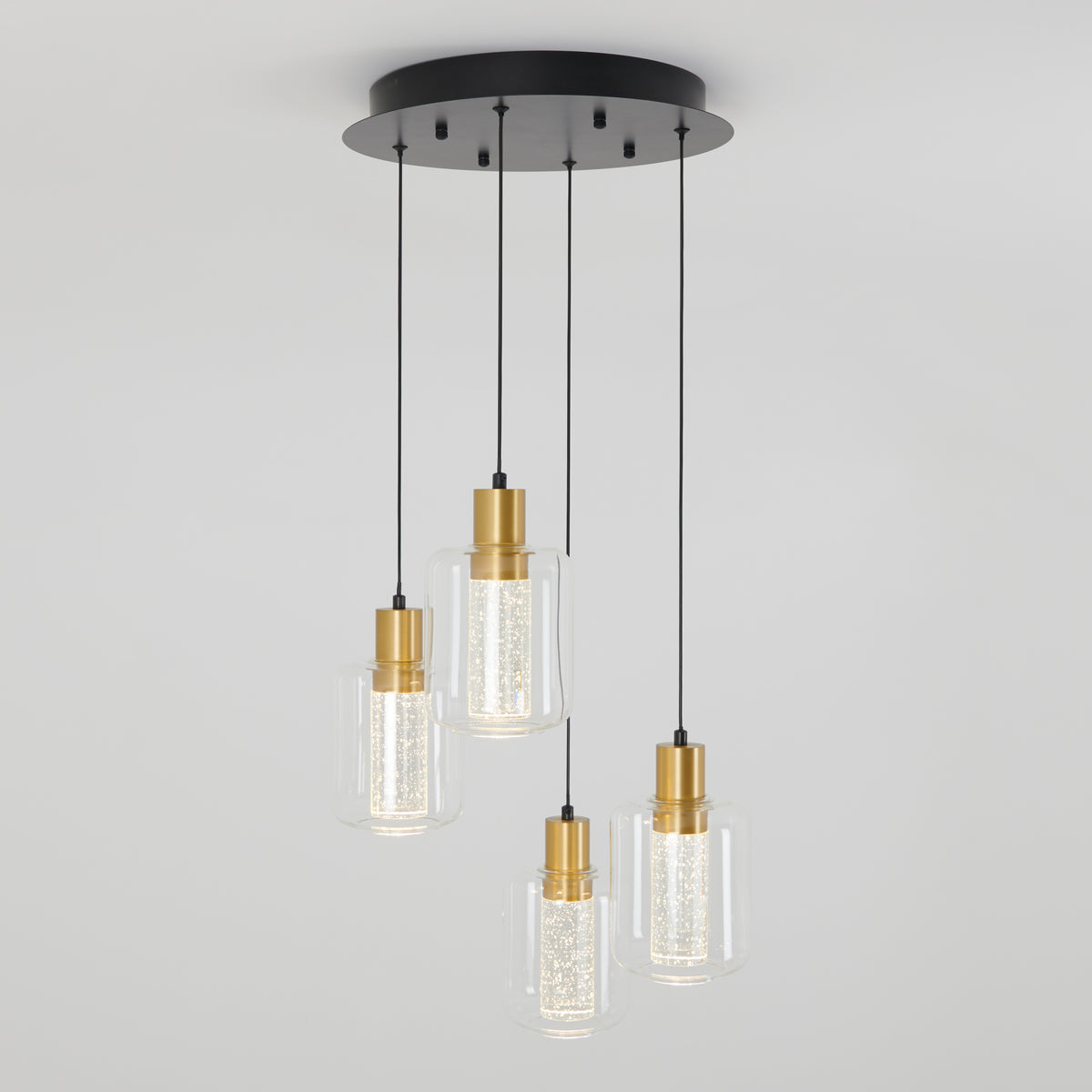 The Artika Champagne Globe 4-light LED pendant features four cylindrical glass shades with gold accents and black cords, all attached to a round black ceiling mount for a modern look.