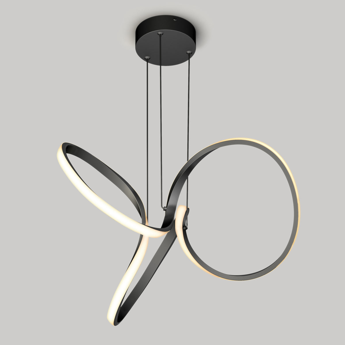 The Artika Swirl LED pendant light features two intertwined black loops outlined with warm white LEDs, suspended from a round black mount by three wires.