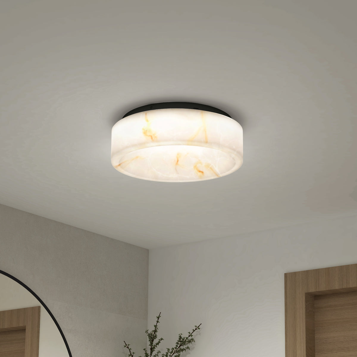 The Clifford 15 in. flush mount light by Artika, featuring a marble-patterned round design and adjustable warm glow, is installed on a white ceiling above a modern interior with a mirror, wall, and wooden door frame in view.