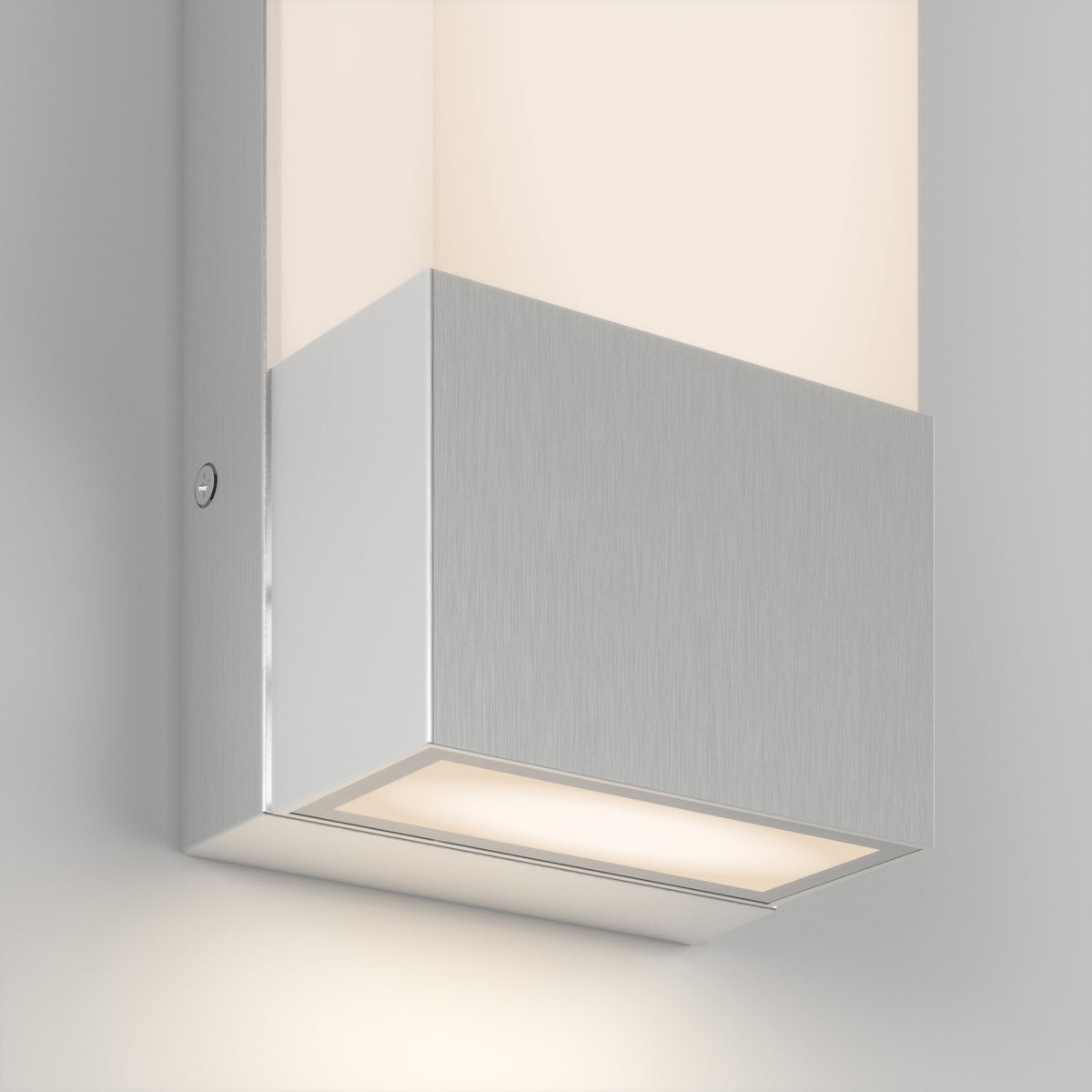 Close-up of the Artika Dixon indoor-outdoor LED wall light, featuring a brushed metal finish and rectangular design that emits soft, warm light both upward and downward.