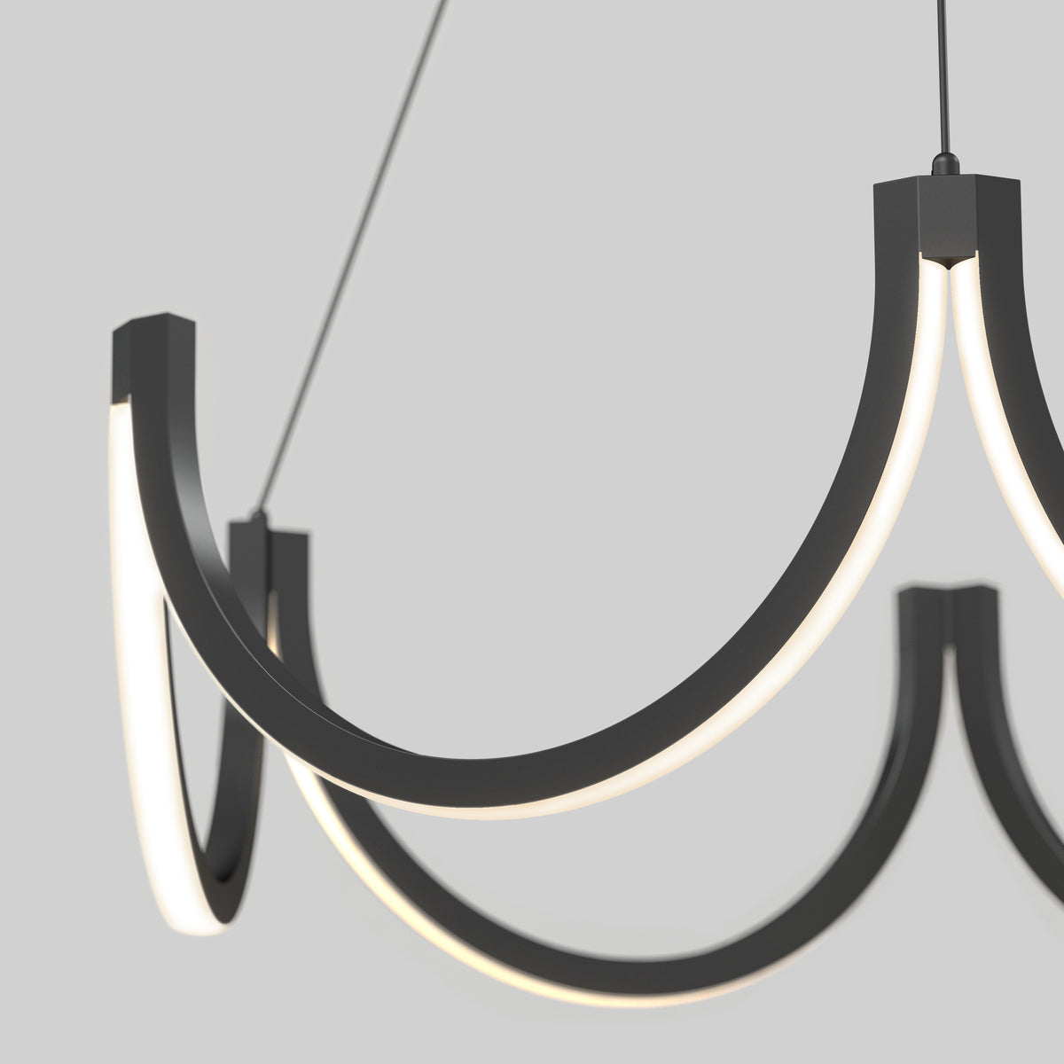 A close-up of the Artika Adelia LED pendant light 5 CCT, a modern, minimalist chandelier with three black curved arms and integrated LED lights, suspended against a plain light gray background.