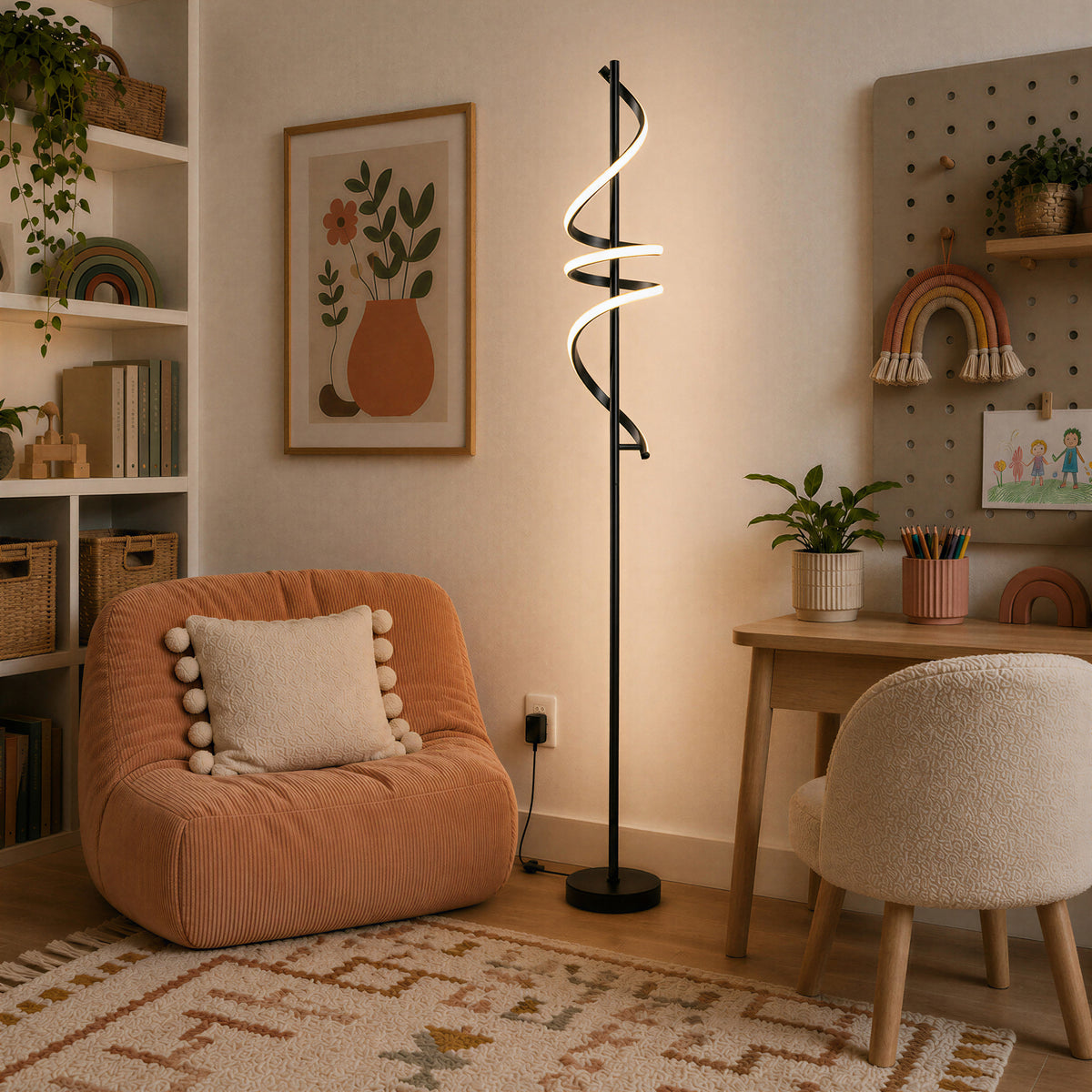 Cozy room with a peach chair, Artika Coda modern LED floor lamp, desk, wall art, plants, and shelves for decor and books.