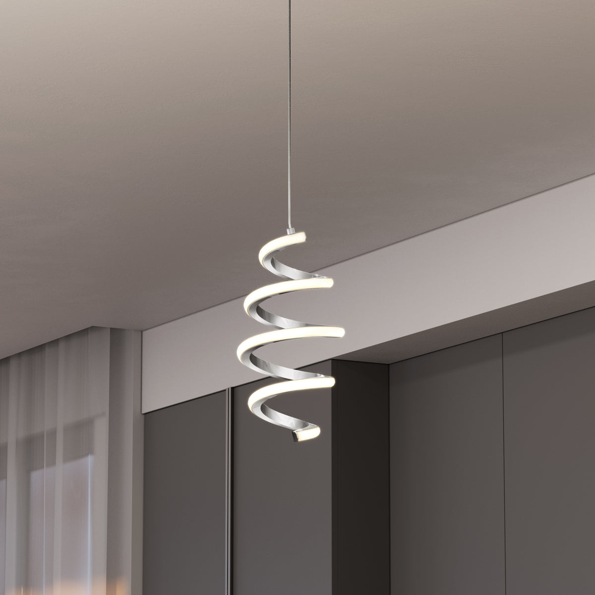 The Artika Chorus 1-light LED pendant 5 CCT hangs from the ceiling in a minimalist room with dark cabinets and sheer curtains.