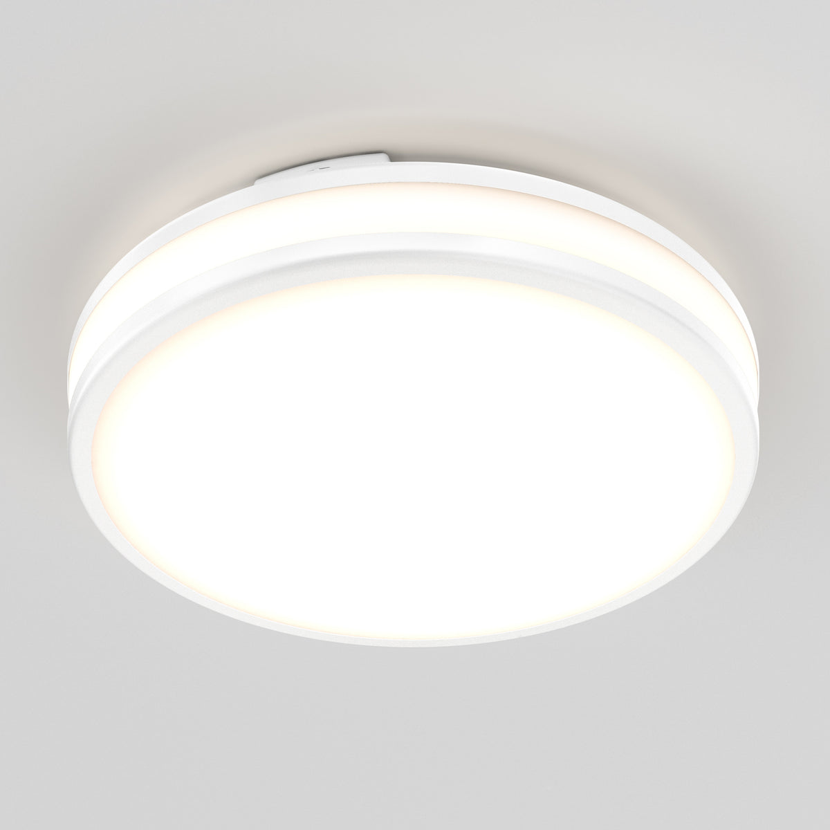 The Artika Hemisphere 15 in. LED flush mount light features a round, white design and offers 5 CCT adjustable brightness, delivering a bright, even glow—ideal for customizable bathroom lighting against any plain ceiling.