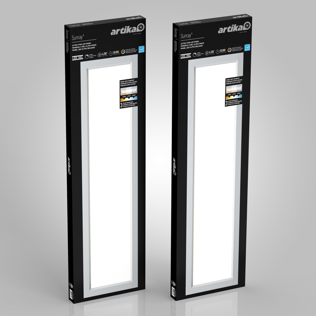 Two rectangular Artika Sunray ultra thin LED light panel 3 CCT boxes are shown upright in black packaging with white accents, product information, and a display window revealing the lights inside.