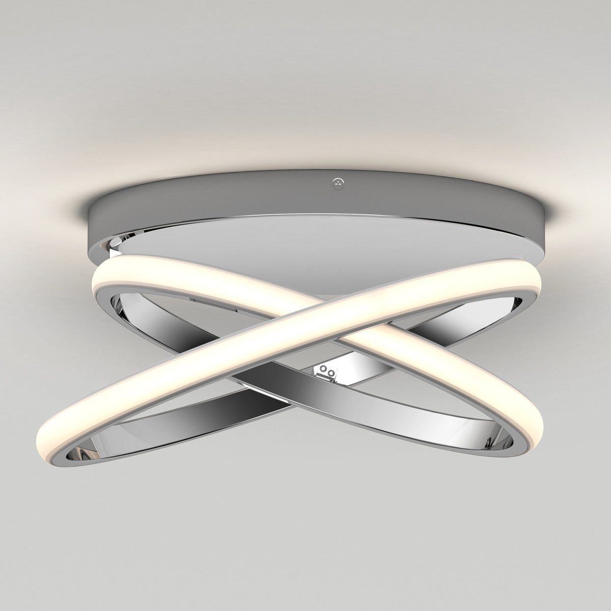 The Orbia modern LED flush mount light 3 CCT by Artika features two interlocking curved LED strips and a polished chrome finish, mounted on a round chrome base against a white ceiling.