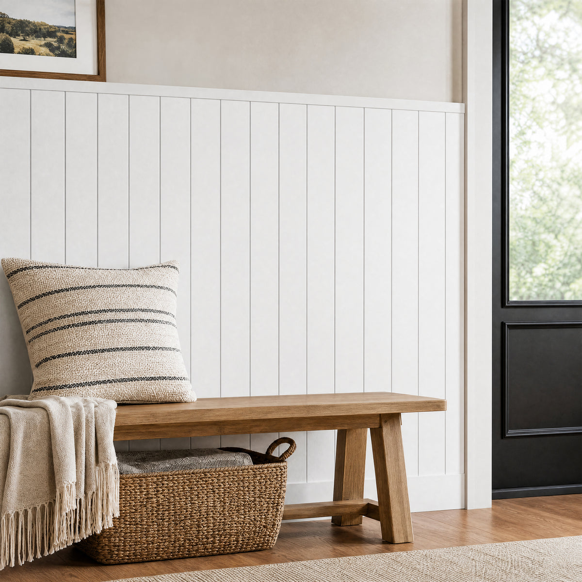 Wooden bench with striped pillow and blanket sits by Artika AXEN Shilap MDF wall panels in a bright entryway with basket and black door.