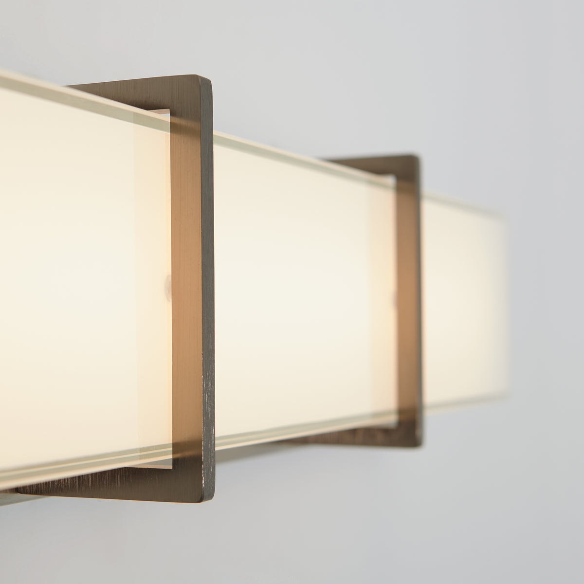 Close-up of Artika’s Subway modern LED bathroom vanity light with frosted glass and metal, delivering warm, soft bathroom lighting.