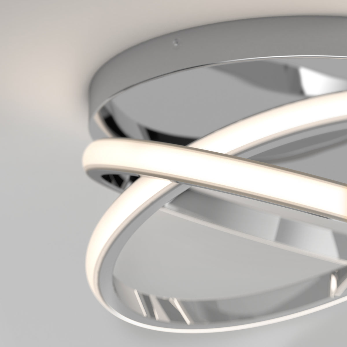 Close-up of the Artika Orbia modern LED flush mount light 3 CCT, featuring two intersecting curved LED bars and a circular metallic base, installed on a white ceiling.