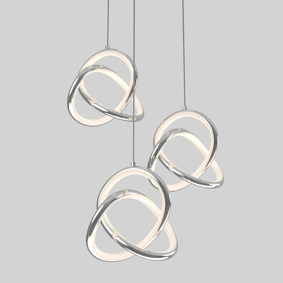 The Artika Zephyr 3-light LED pendant features intertwined chrome and glowing white loops hanging at varying heights against a light gray background, exemplifying sleek modern lighting.