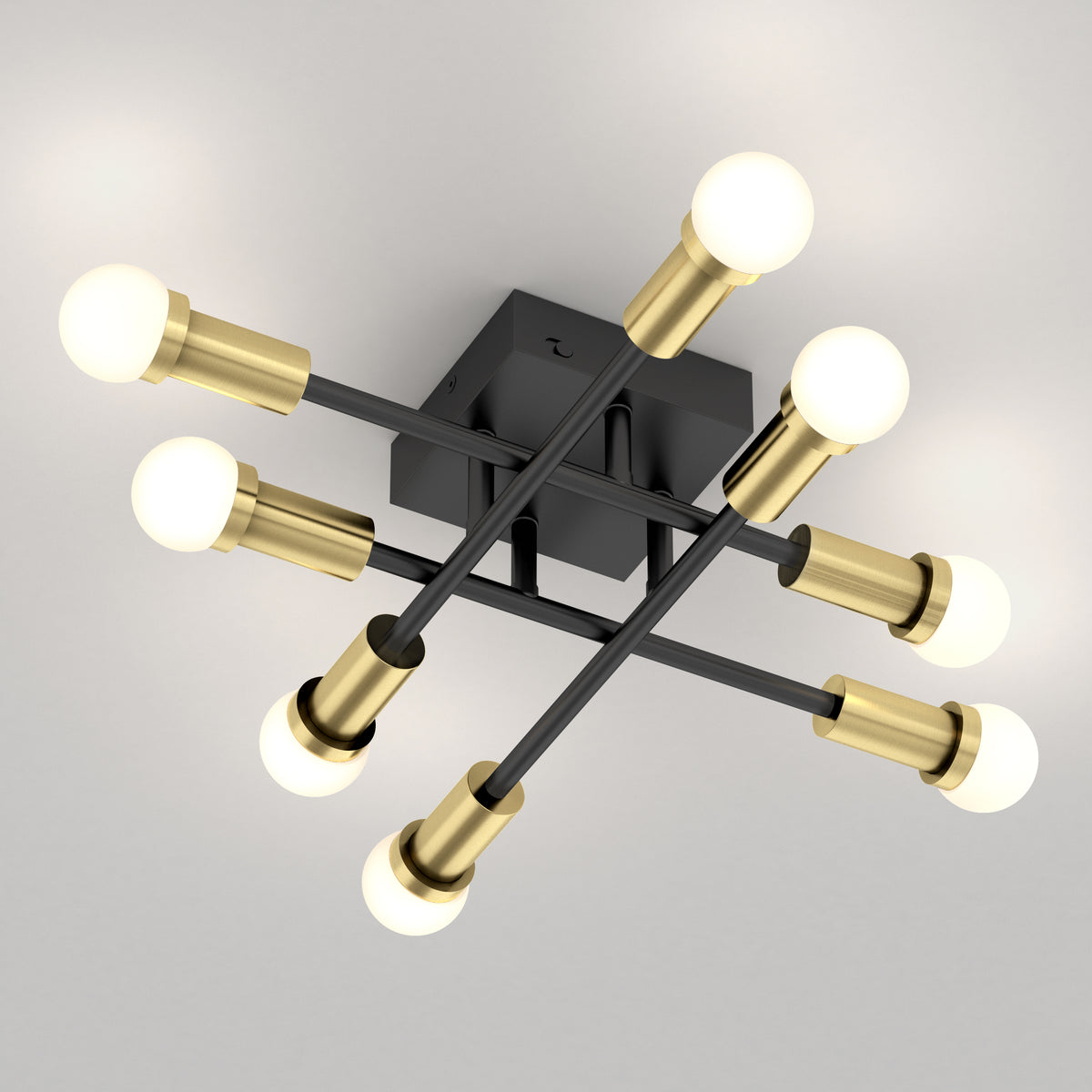 The Aristo LED flush mount by Artika features 6 bulbs, black intersecting rods, gold sockets, and adjustable color temperature.