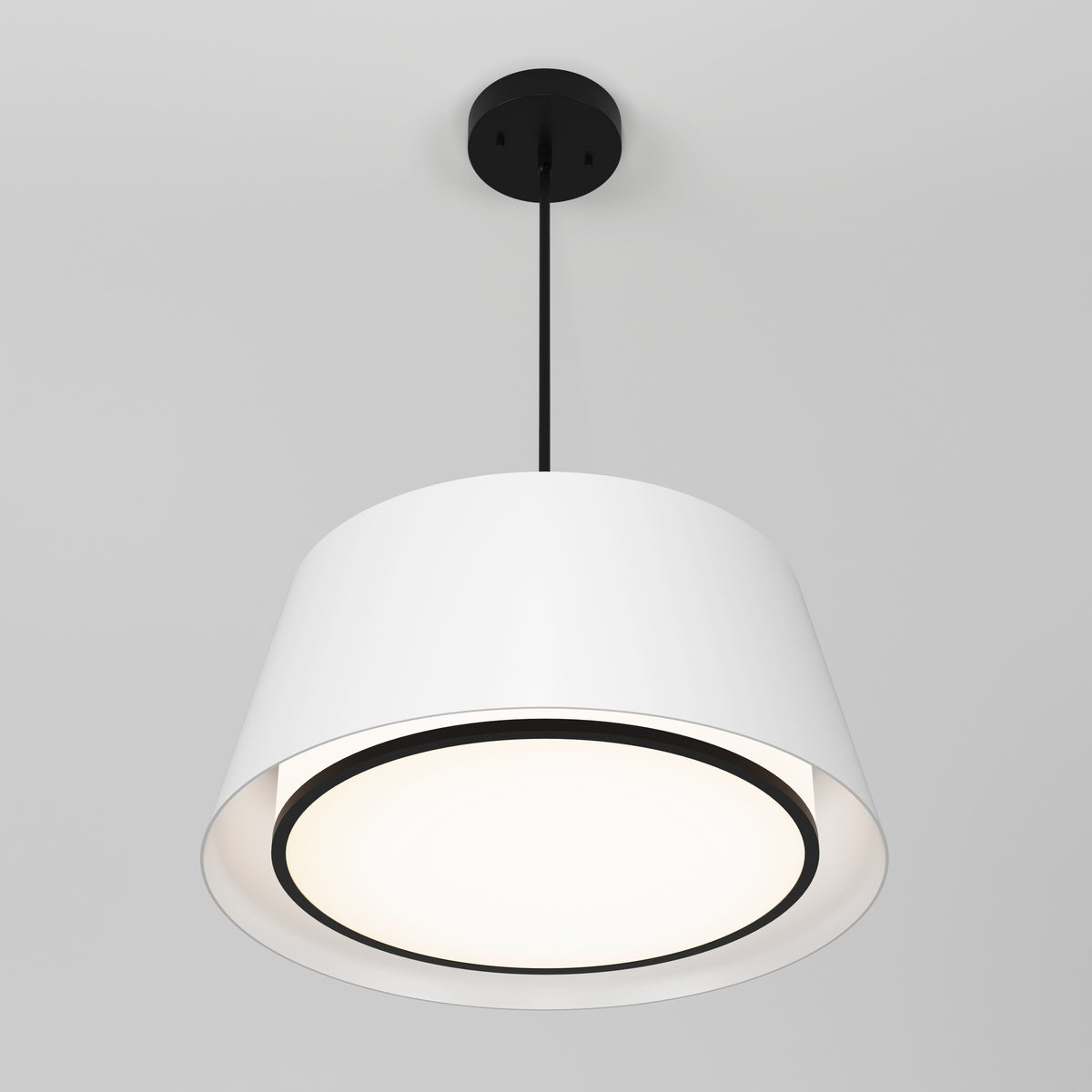 The Cappa LED pendant light 3 CCT by Artika features a wide white shade and black base, suspended by a black cord from a white ceiling. Its LED illumination casts a soft, inviting glow.